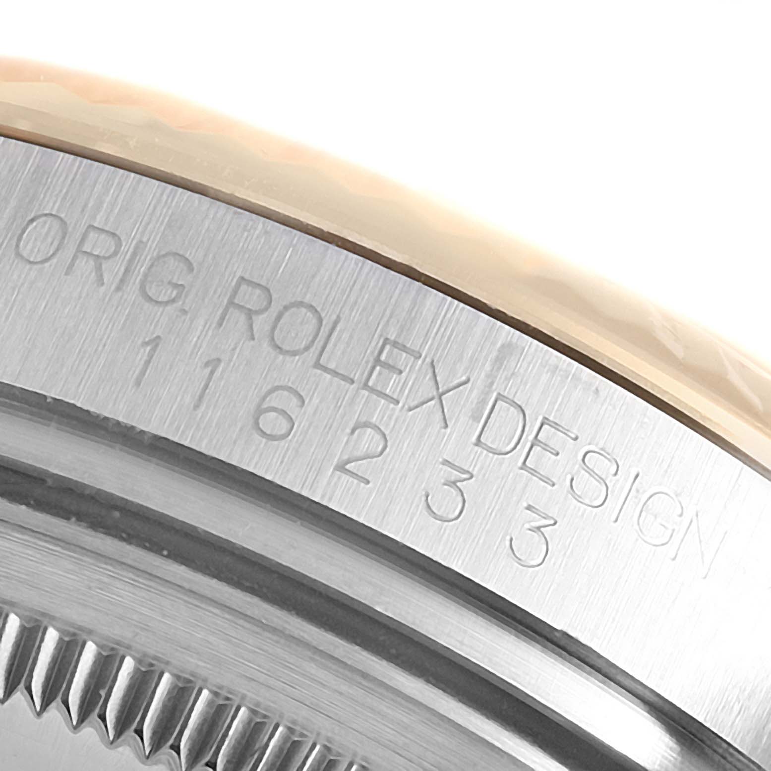 The image shows a close-up of the case edge of a Rolex Datejust 116233 Men
s Steel and Gold (two tone) Silver Dial, highlighting the engraved serial number.