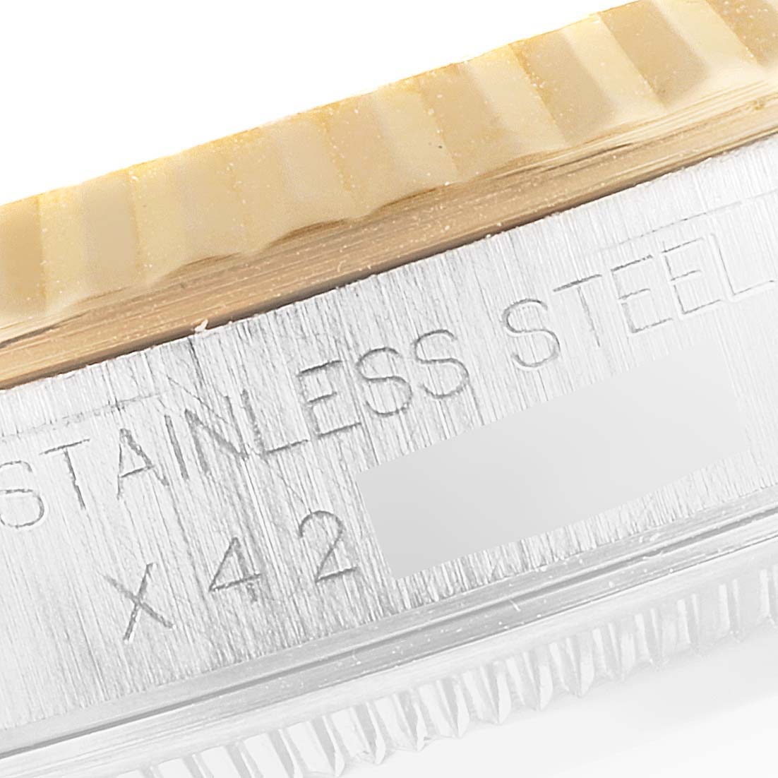 The image shows a close-up of the side inscription and bezel of a Rolex Datejust 16233 Men's Steel and Gold (two tone) Blue Dial 16233 Men's Steel and Gold (two tone) Blue Dial model watch.