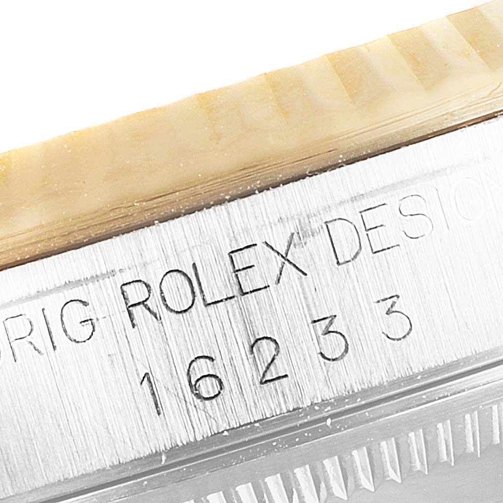 Close-up of Rolex Datejust 16233 Men's Steel and Gold (two tone) Blue Dial 16233 Men's Steel and Gold (two tone) Blue Dial model 16233 showing the engraving on the case side.