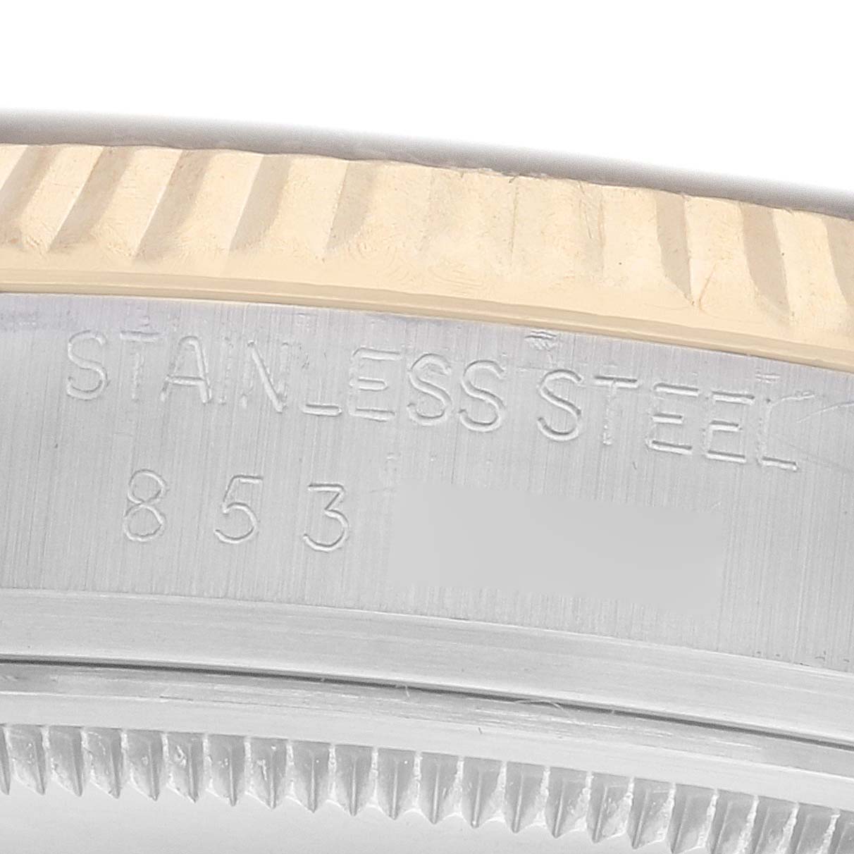 The image shows a close-up of the Rolex Vintage Collection 16013 Men
s Steel and Gold (two tone) Champagne Dial watch case, highlighting the stainless steel engraving.