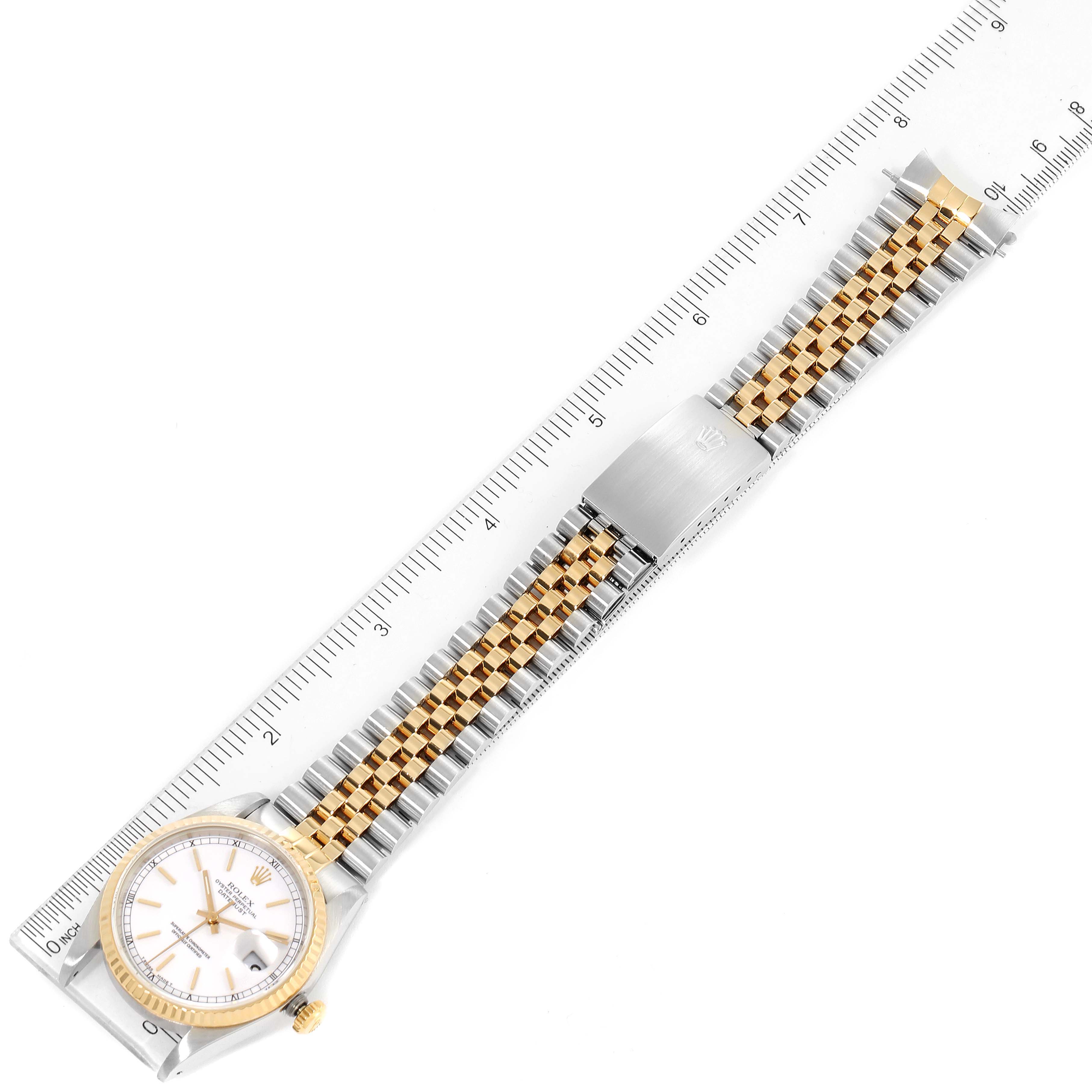 The image shows a Rolex Datejust 16233 Men's Steel and Gold (two tone) White Dial 16233 Men's Steel and Gold (two tone) White Dial watch laid flat, displaying the face, bezel, and full bracelet stretched along a ruler.