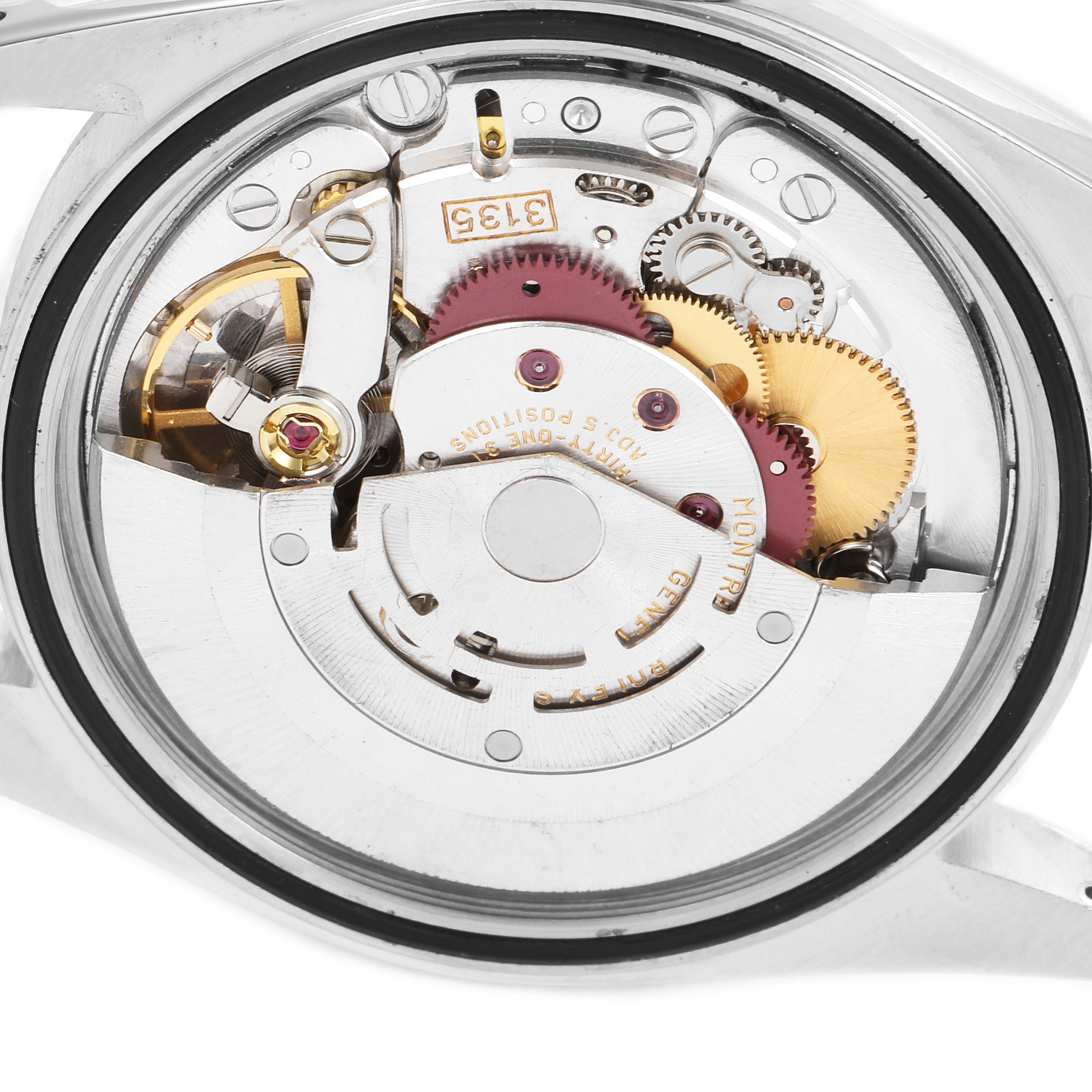 The image shows the movement mechanism of a Rolex Datejust 16233 Men's Steel and Gold (two tone) White Dial 16233 Men's Steel and Gold (two tone) White Dial watch from the back, displaying gears and components.