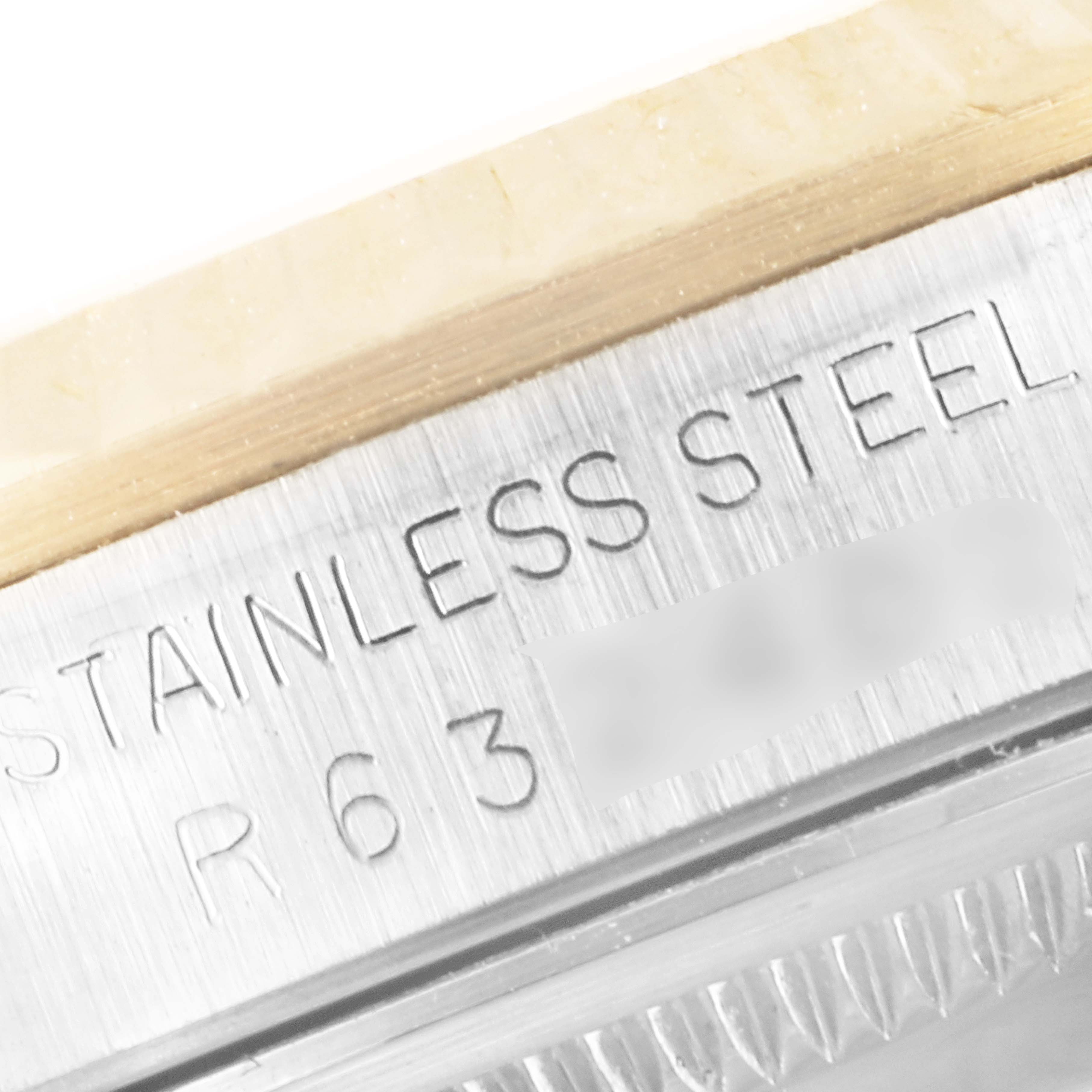 The image shows a close-up of the side engravings on the stainless steel case of a Rolex Datejust 16233 Men's Steel and Gold (two tone) White Dial 16233 Men's Steel and Gold (two tone) White Dial watch.