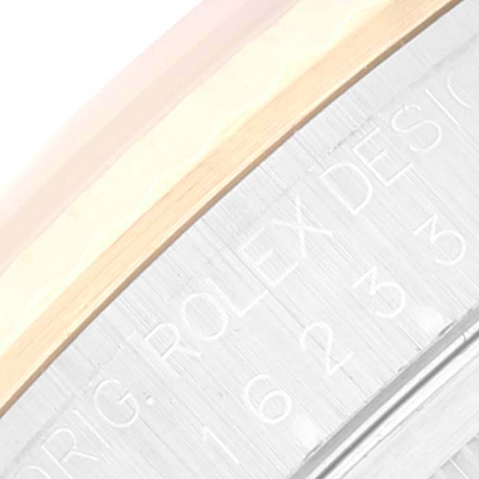 This image shows a close-up of the engraved side case of a Rolex Datejust 16233 Men's Steel and Gold (two tone) White Dial 16233 Men's Steel and Gold (two tone) White Dial watch.