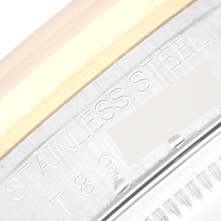 The image shows a close-up of the bezel and part of the stainless steel case of a Rolex Datejust 16233 Men's Steel and Gold (two tone) White Dial 16233 Men's Steel and Gold (two tone) White Dial watch.