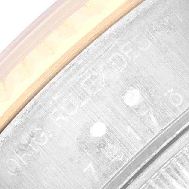 This image shows a close-up of the serial number engraving on the metallic part of the Rolex Datejust 79173 Women's Steel and Gold (two tone) White Dial 79173 Women's Steel and Gold (two tone) White Dial watch case.