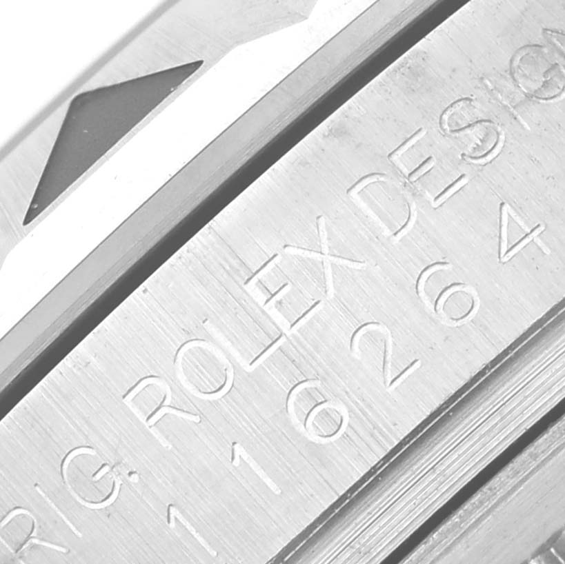 The image shows a close-up of the side engraving on a Rolex Turn-o-Graph 116264 Men's Stainless Steel Black Dial 116264 Men's Stainless Steel Black Dial model, highlighting the serial and design numbers.