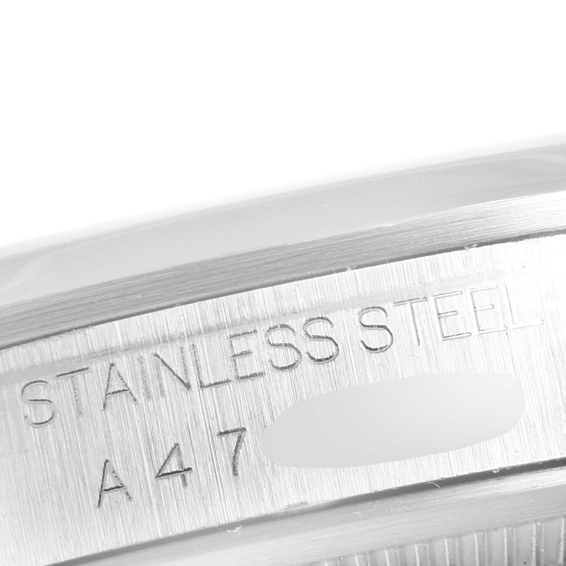 This close-up image shows the side engraving on the stainless steel case of a Rolex Explorer 114270 Men
s Stainless Steel Black Dial 114270 Men
s Stainless Steel Black Dial watch.