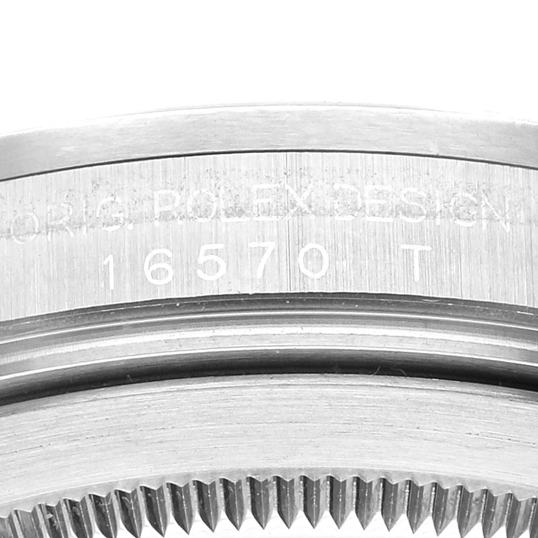 The image shows a close-up view of the side engraving and bezel teeth of a Rolex Explorer 16570 Men
s Stainless Steel White Dial 16570 Men
s Stainless Steel White Dial watch, model 16570.