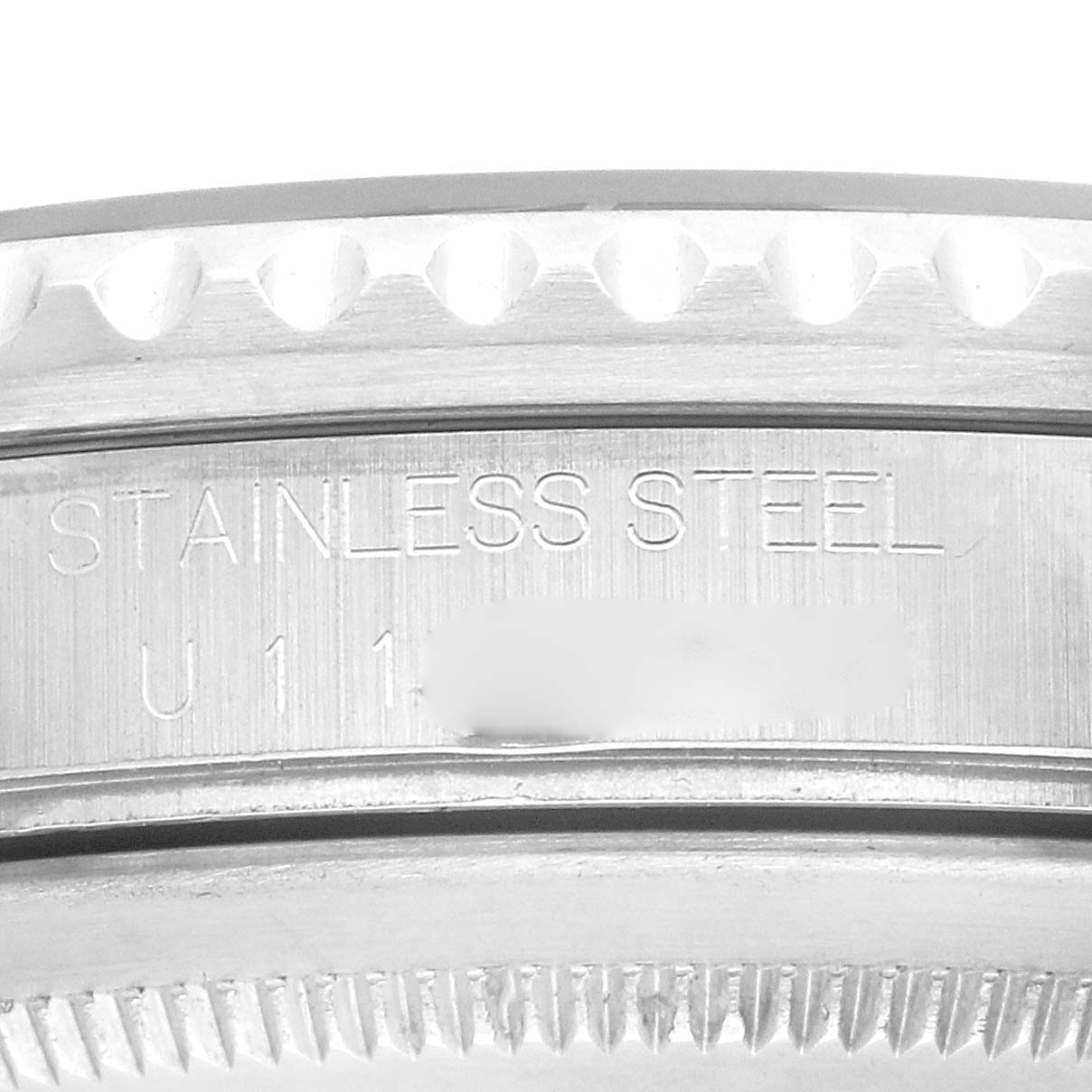 The image shows a close-up of the side of a Rolex GMT-Master 16700 Men
s Stainless Steel Black Dial watch, highlighting the stainless steel marking and serial number.