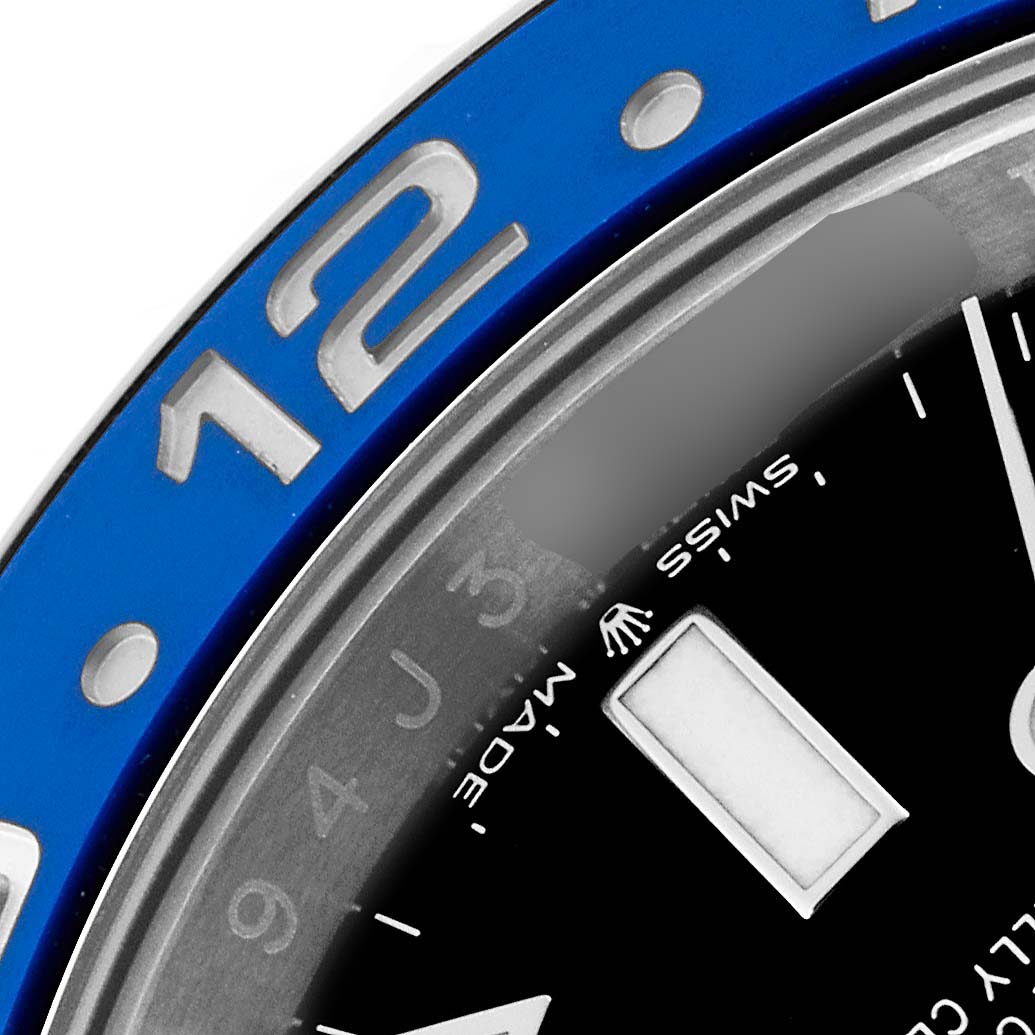 The image shows a close-up of the dial and bezel of a Rolex GMT-Master 126710 Men
s Stainless Steel Black Dial 126710 Men
s Stainless Steel Black Dial watch, focusing on the hour marker and part of the "Swiss Made" text.