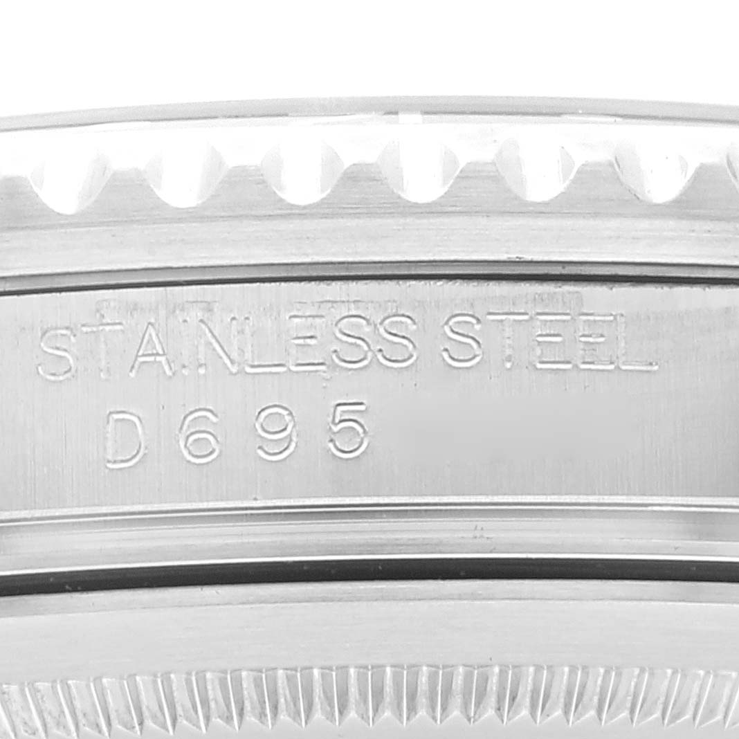 The image shows a close-up of the side of a Rolex GMT-Master 16710 Men's Stainless Steel Black Dial 16710 Men's Stainless Steel Black Dial, highlighting the "STAINLESS STEEL" and production number engraving.