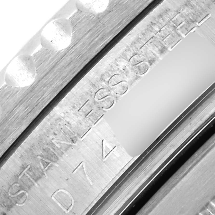 This image shows a macro view of the Rolex GMT-Master 16710 Men's Stainless Steel Black Dial 16710 Men's Stainless Steel Black Dial watch's stainless steel case with visible engravings.