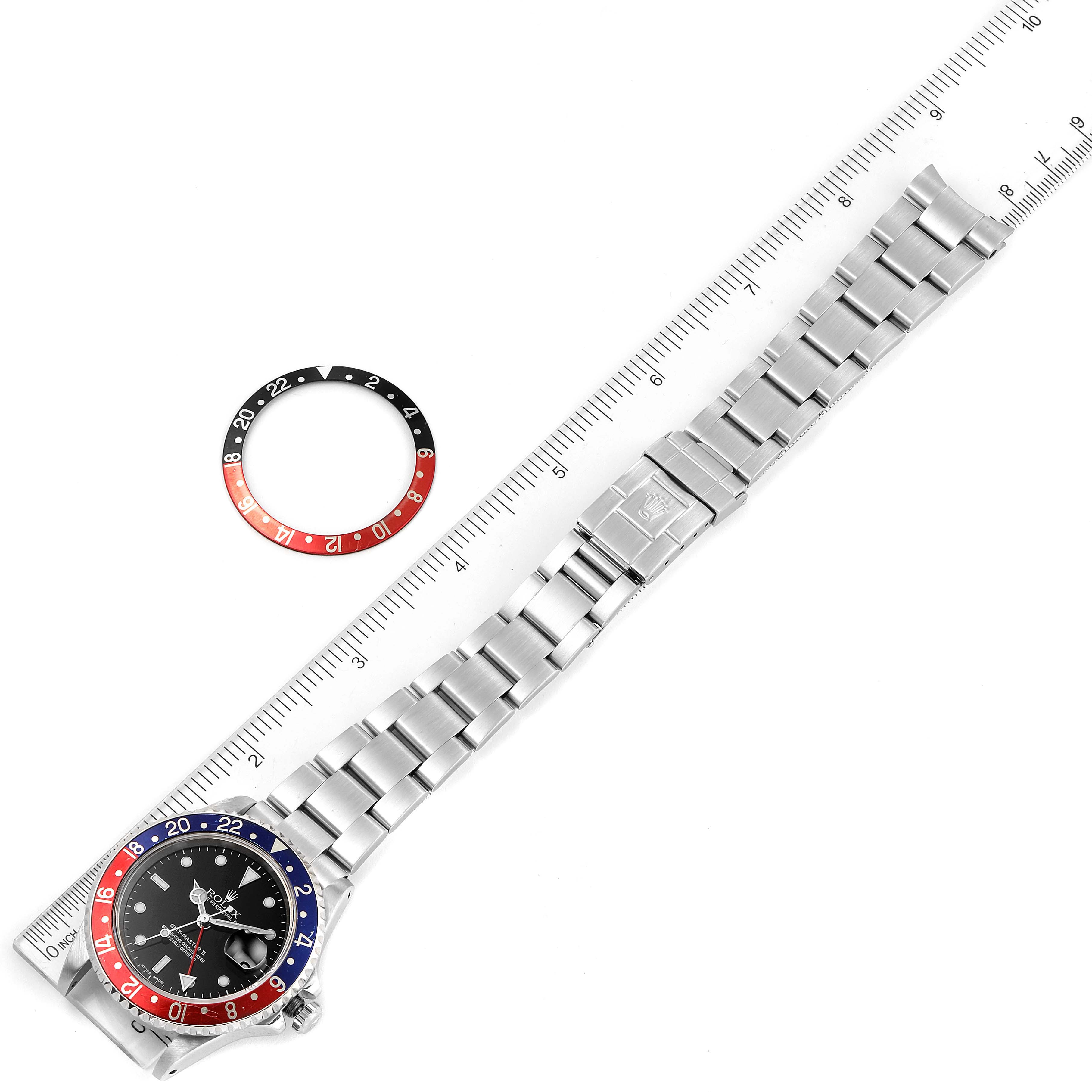 The image shows a Rolex GMT-Master 16710 Men
s Stainless Steel Black Dial 16710 Men
s Stainless Steel Black Dial watch laid flat with its bracelet extended and a separate bezel ring beside it.