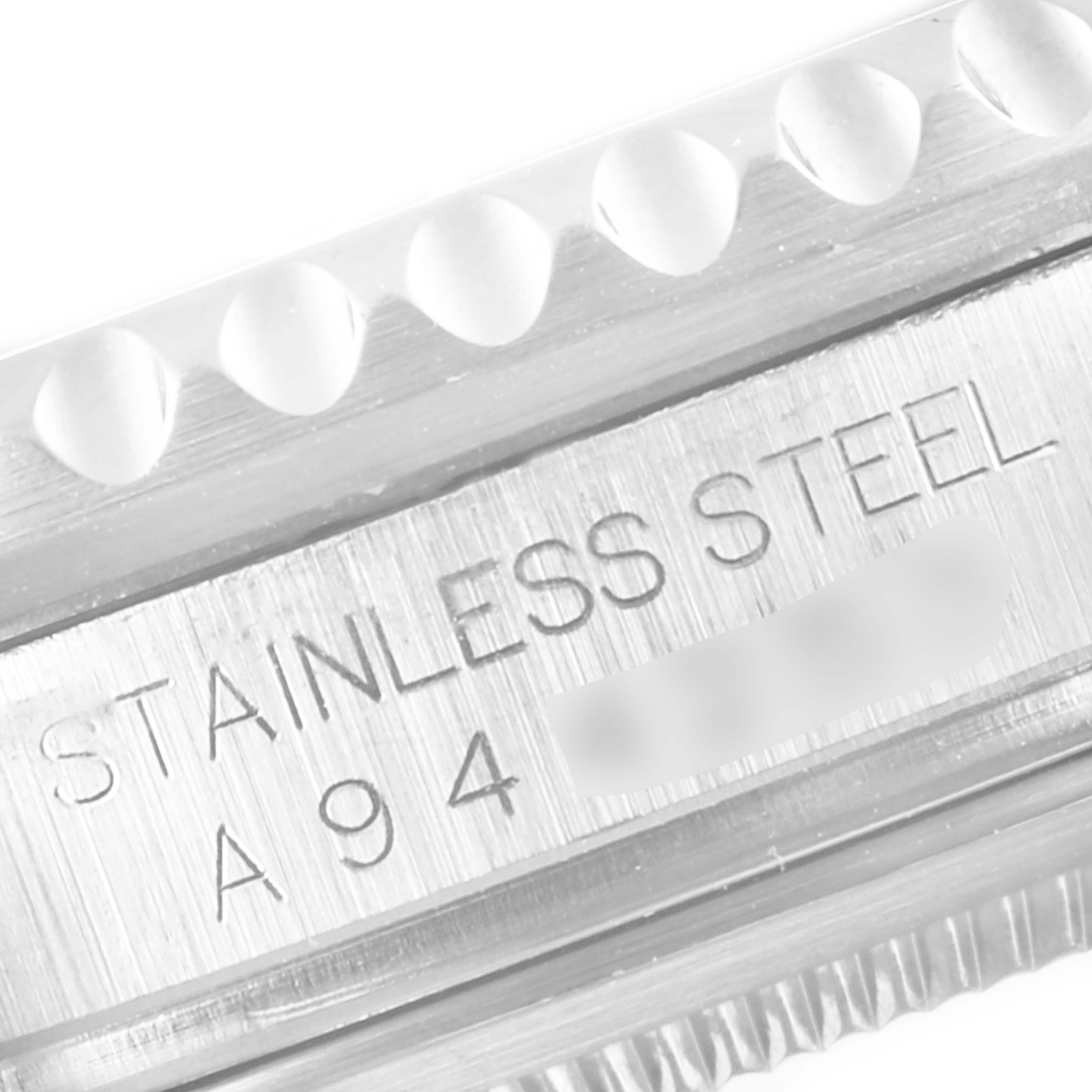 This image shows a close-up of the case side of a Rolex GMT-Master 16710 Men
s Stainless Steel Black Dial 16710 Men
s Stainless Steel Black Dial watch, highlighting the "Stainless Steel" engraving.