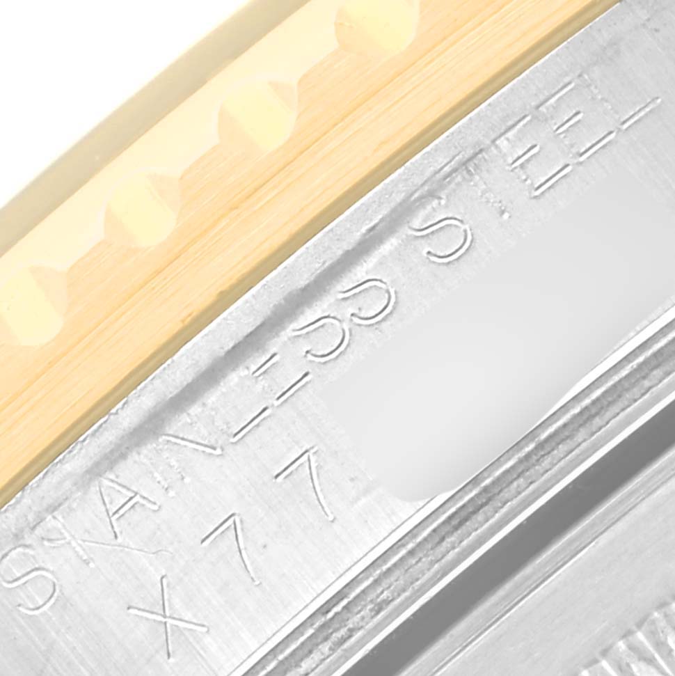 The image shows a close-up view of the casing with engraved text and part of the bezel of a Rolex GMT-Master 16713 Men's Steel and Gold (two tone) Black Dial 16713 Men's Steel and Gold (two tone) Black Dial watch.