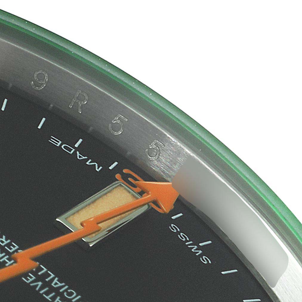 This close-up angle of the Rolex Milgauss 116400GV Men's Stainless Steel Black Dial 116400GV Men's Stainless Steel Black Dial watch shows the green tinted crystal, orange lightning bolt seconds hand, and part of the dial.