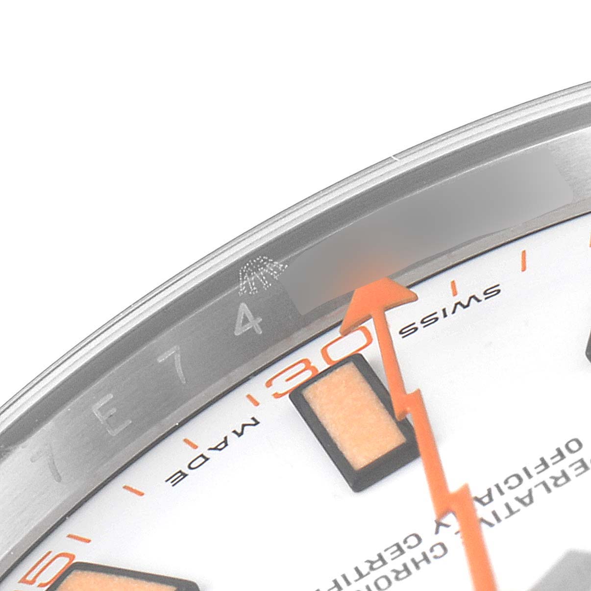 The image shows a close-up of the Rolex Milgauss 116400 Men's Stainless Steel White Dial 116400 Men's Stainless Steel White Dial watch, focusing on the dial, bezel, and part of the orange lightning-bolt second hand.