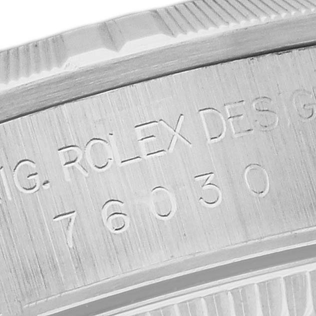 This image shows a close-up view of the engraved side of the bezel and case for a Rolex Oyster Perpetual 76030 Women's Stainless Steel Blue Dial 76030 Women's Stainless Steel Blue Dial watch.