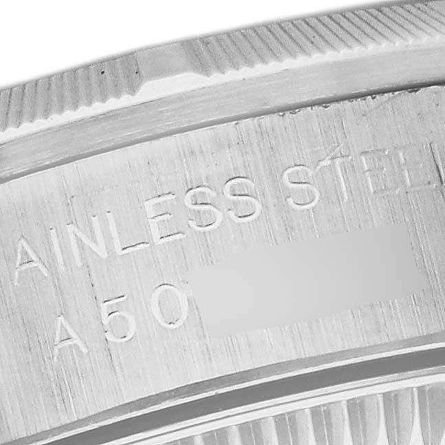 This close-up image shows the stainless steel casing and part of the engraved serial number of a Rolex Oyster Perpetual 76030 Women's Stainless Steel Blue Dial 76030 Women's Stainless Steel Blue Dial watch.