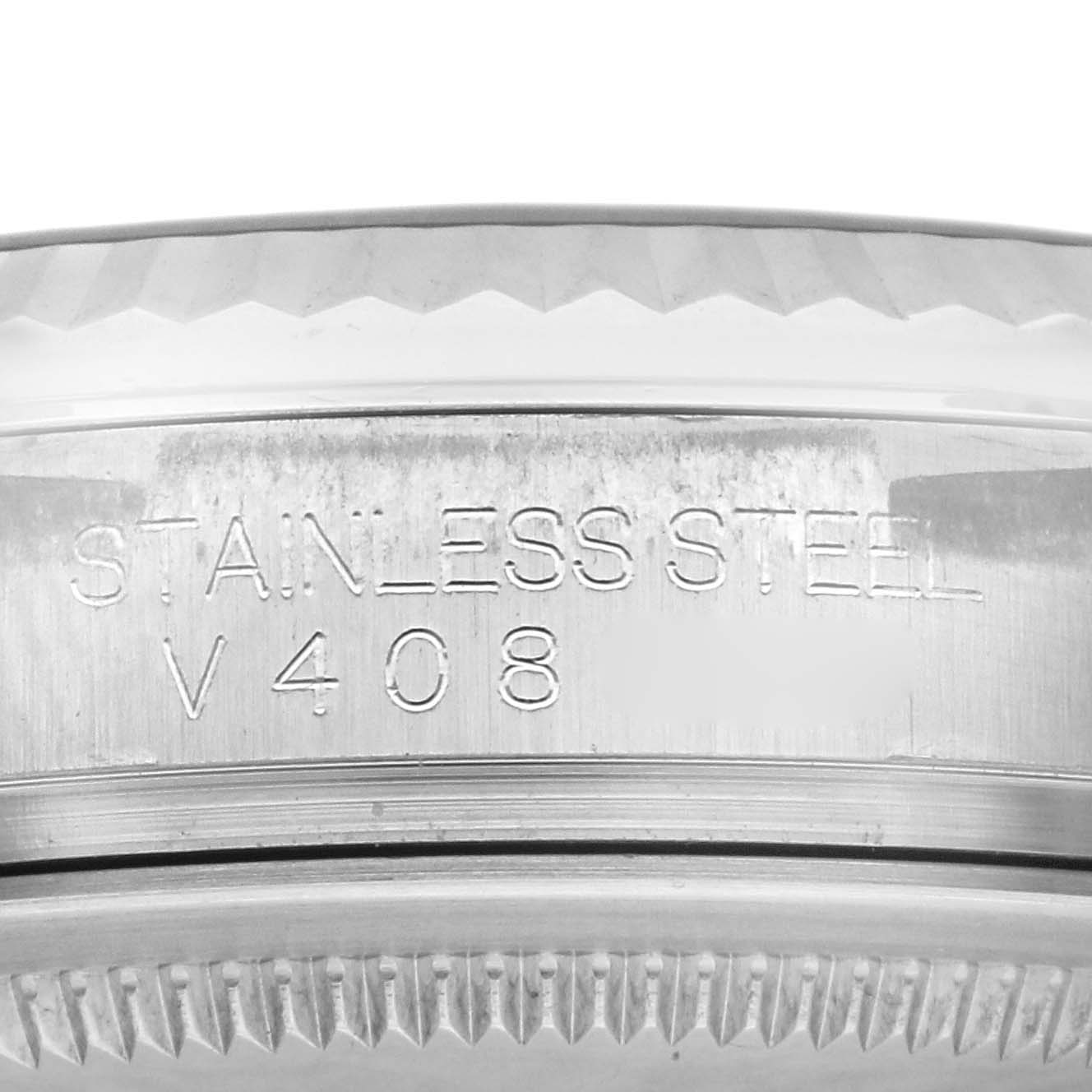 The image shows a close-up of the engraved text on the stainless steel case back of a Rolex Oyster Perpetual 116034 Men's Stainless Steel Black Dial 116034 Men's Stainless Steel Black Dial watch.
