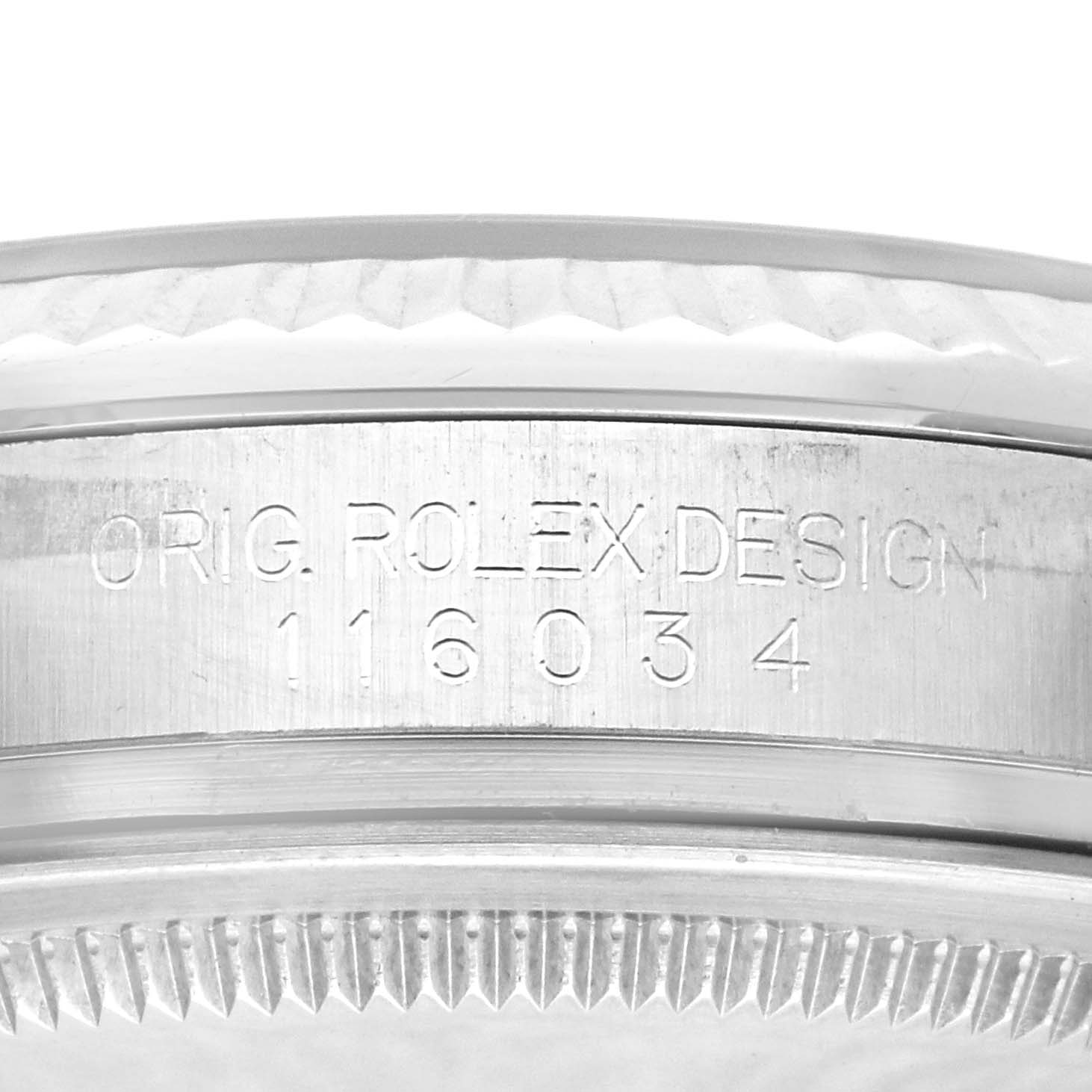 This image shows a close-up of the side of the Rolex Oyster Perpetual 116034 Men's Stainless Steel Black Dial 116034 Men's Stainless Steel Black Dial watch case featuring the engraved model number 116034.