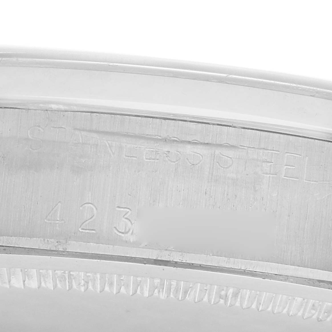 The image shows a close-up of the engraved stainless steel edge on the Rolex Vintage Collection 6694 Men
s Stainless Steel Blue Dial watch case.
