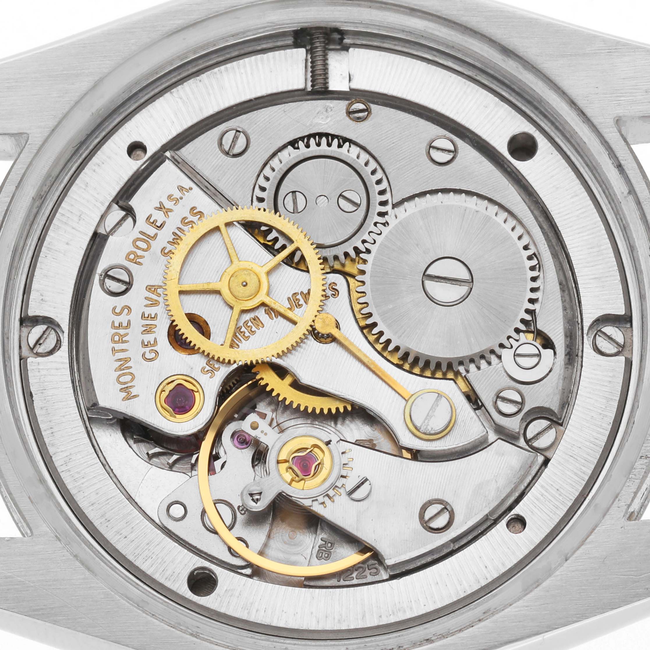 The image shows a close-up of the movement parts of a Rolex Vintage Collection 6694 Men
s Stainless Steel Blue Dial watch, highlighting gears and intricate components.