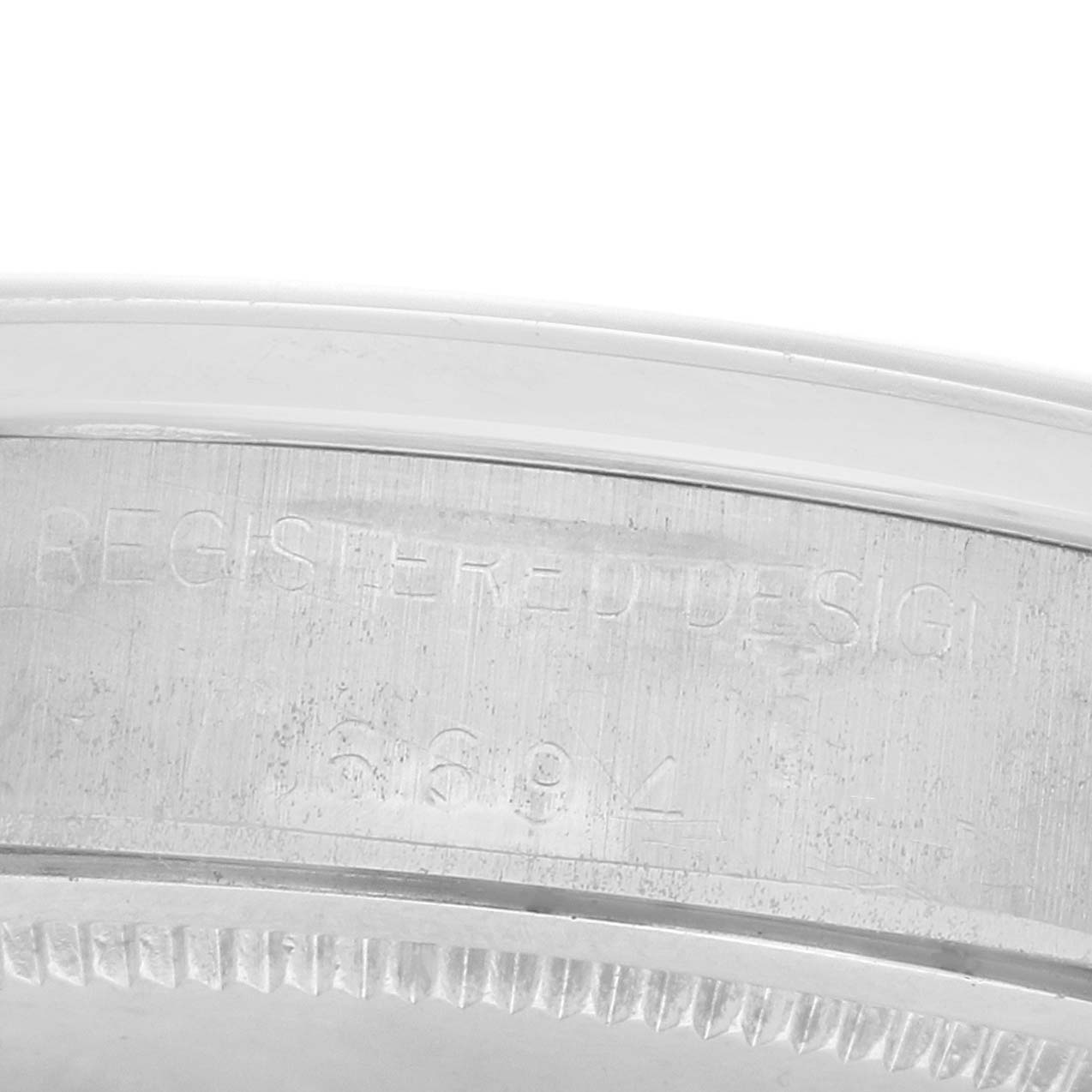 The image shows a close-up angle of the serial number and design details on the case edge of a Rolex Vintage Collection 6694 Men
s Stainless Steel Blue Dial watch.