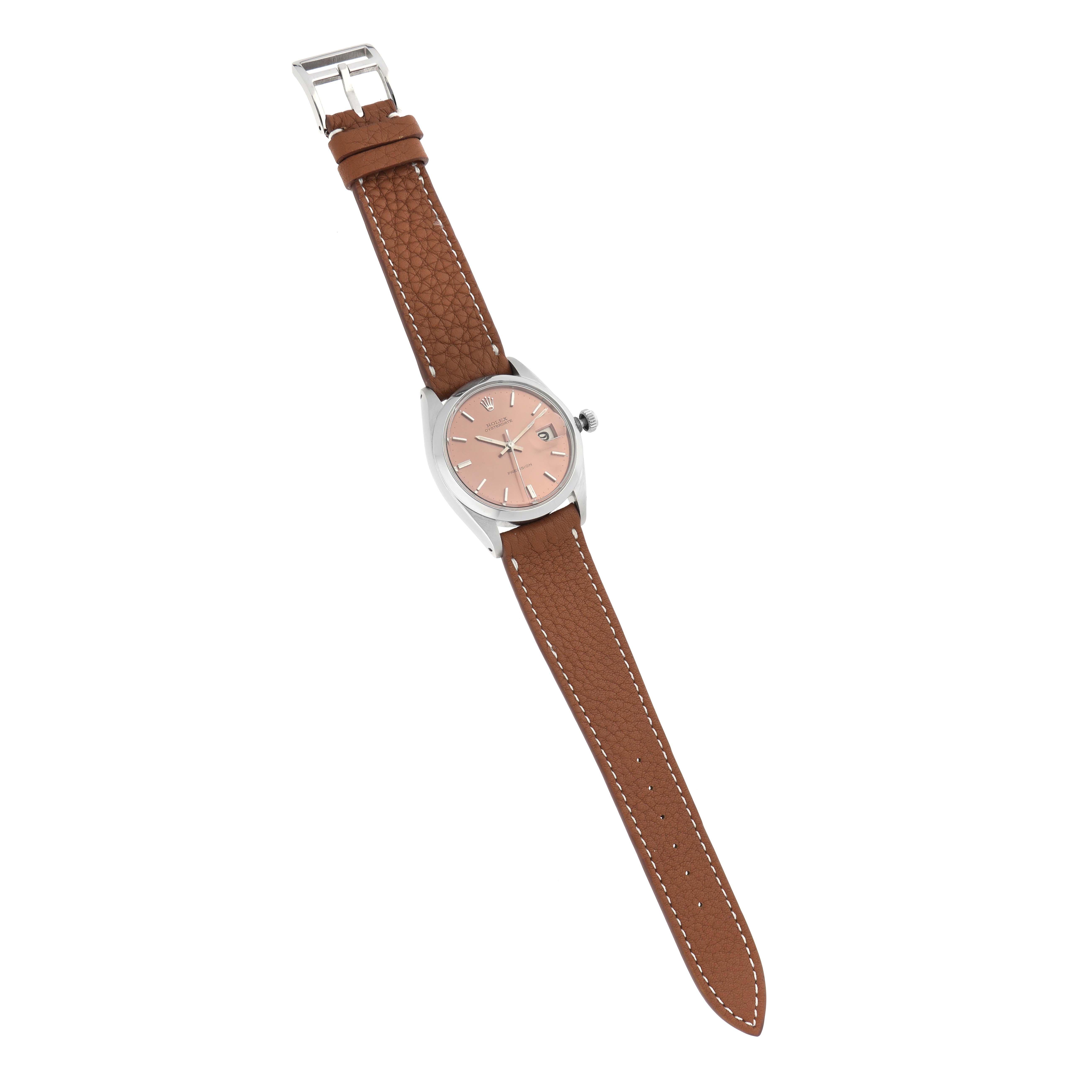 The Rolex Vintage Collection 6694 Men
s Stainless Steel Pink Dial watch is shown at a slight angle, displaying the face, bezel, leather strap, and clasp clearly.