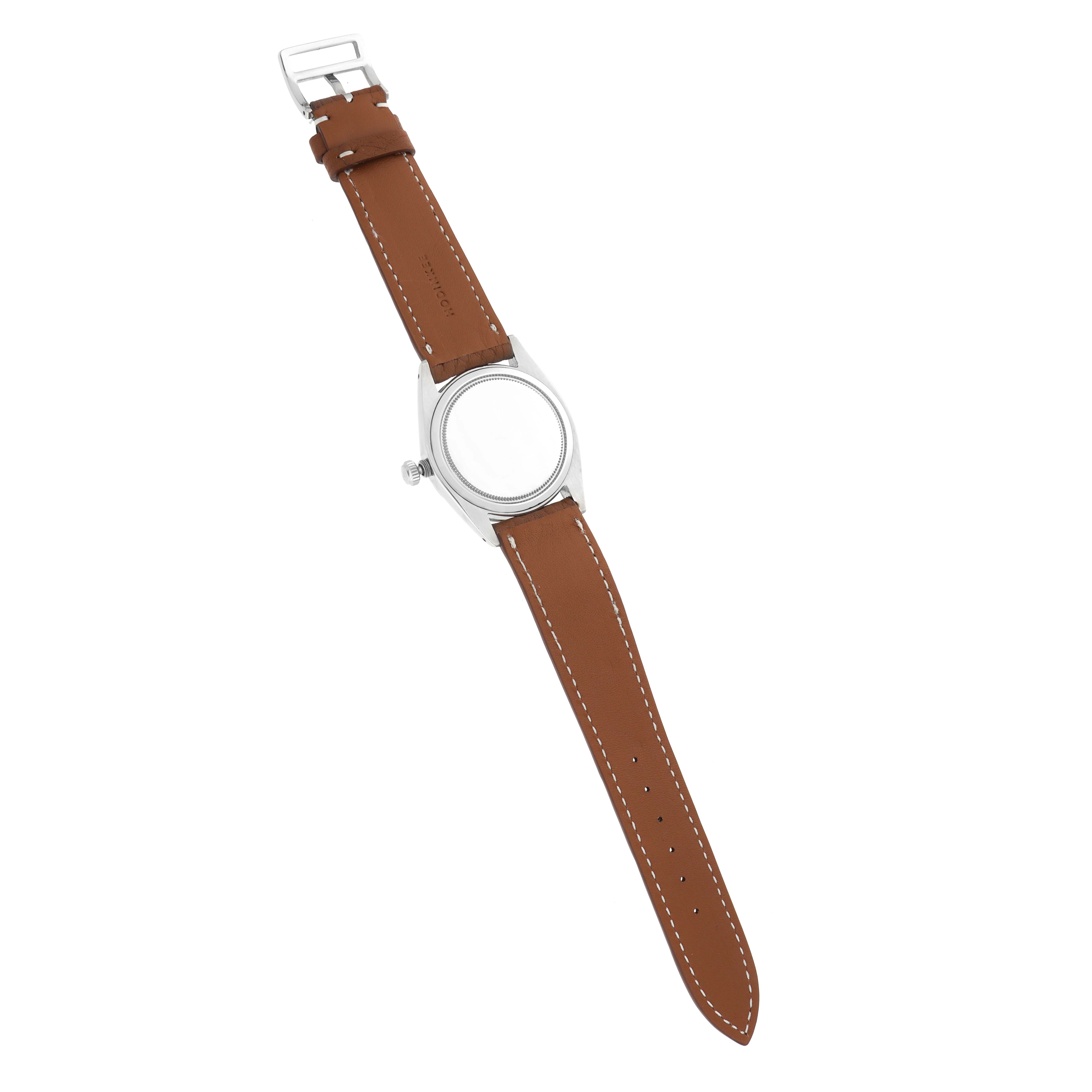 The image shows a Vintage Collection Rolex watch from the back, highlighting the brown leather strap and case back.