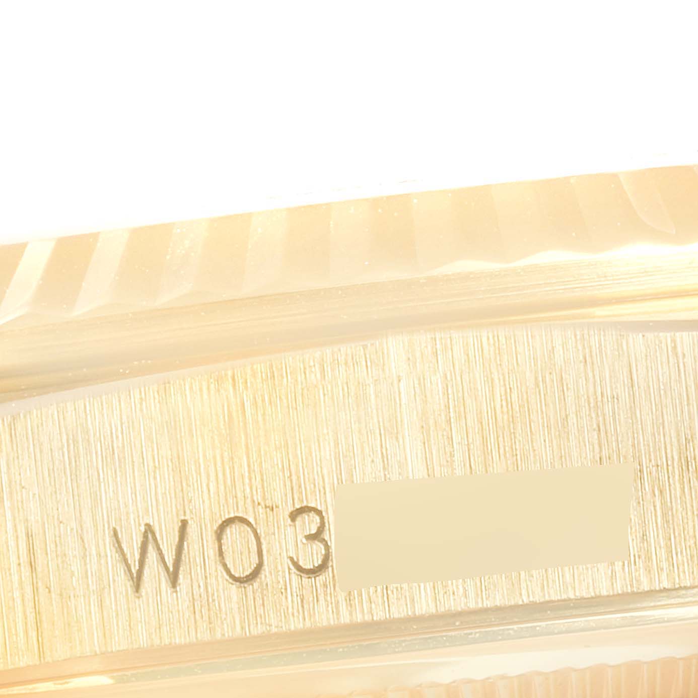 The image shows a close-up of the side engraving on a Rolex President 18338 Men
s Yellow Gold Champagne Dial 18338 Men
s Yellow Gold Champagne Dial model watch.