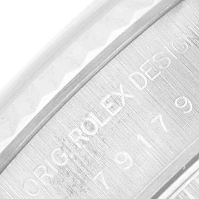 This close-up angle shows the engraved text on the side of the Rolex President 79179 Women's White Gold Mother of Pearl Dial 79179 Women's White Gold Mother of Pearl Dial model watch case.
