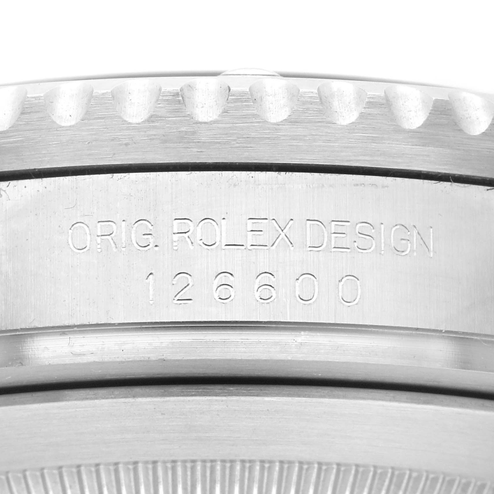 The image shows the side view of a Rolex Sea-Dweller 126600 Men
s Stainless Steel Black Dial 126600, focusing on the engraved bezel and case design.