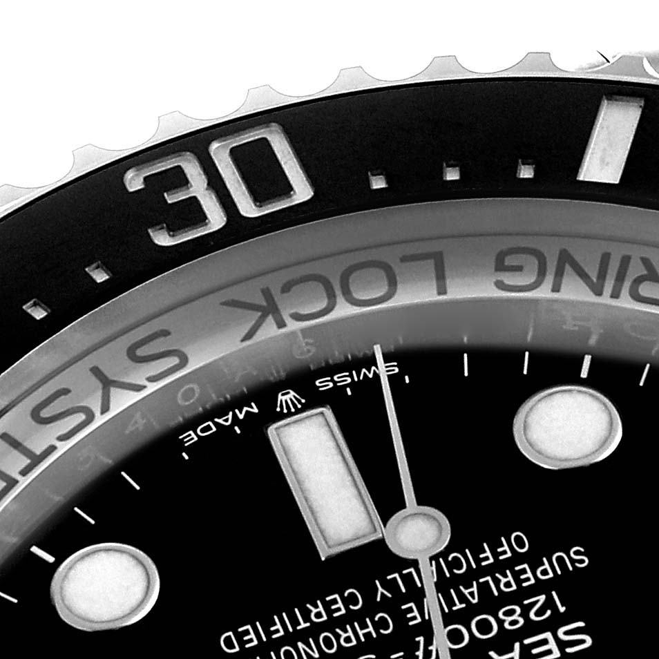 The image shows a close-up view of the bezel, 'Ring Lock System,' and part of the dial of a Rolex Sea-Dweller 126660 Men's Stainless Steel Black Dial 126660 Men's Stainless Steel Black Dial watch.