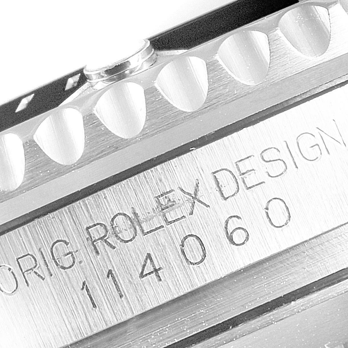 This image shows a close-up of the engraved serial number and part of the bezel of a Rolex Submariner 114060 Men
s Stainless Steel Black Dial 114060 Men
s Stainless Steel Black Dial watch.