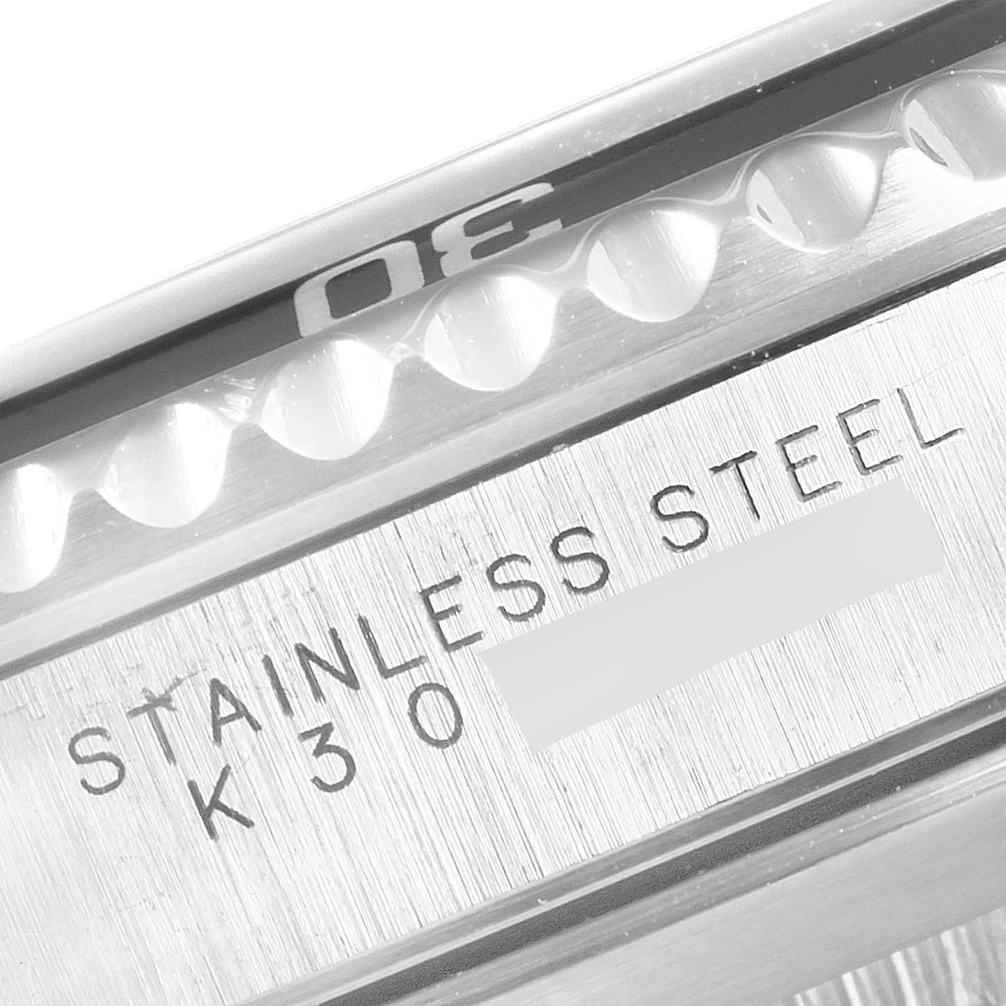 The image shows a close-up of the Rolex Submariner 14060 Men
s Stainless Steel Black Dial 14060 Men
s Stainless Steel Black Dial
s stainless steel bezel and part of the case, highlighting the "30" marker and the "STAINLESS STEEL K30" engraving.