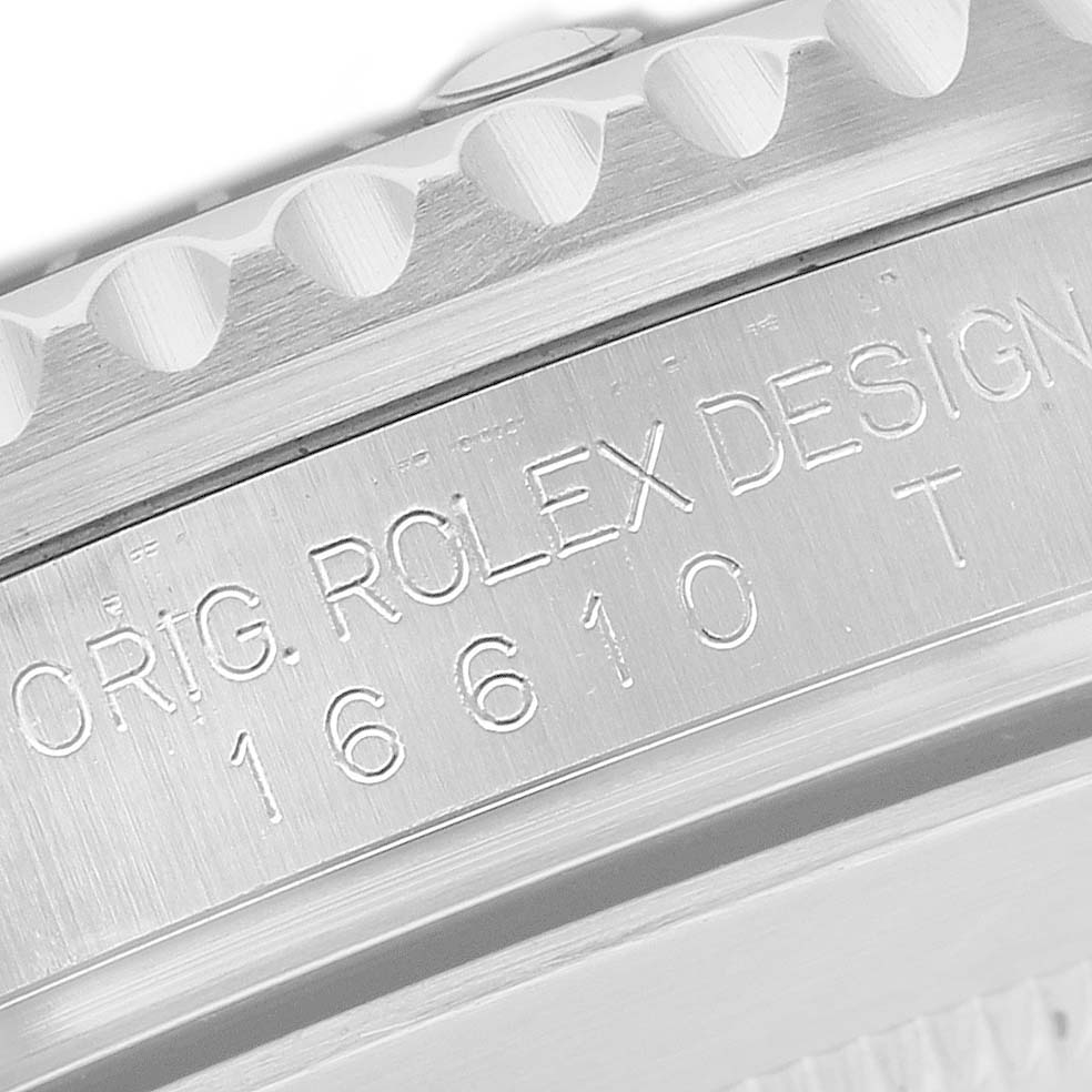 The image shows a close-up of the engraving on the side of a Rolex Submariner 16610 Men's Stainless Steel Black Dial case, displaying model and design details.