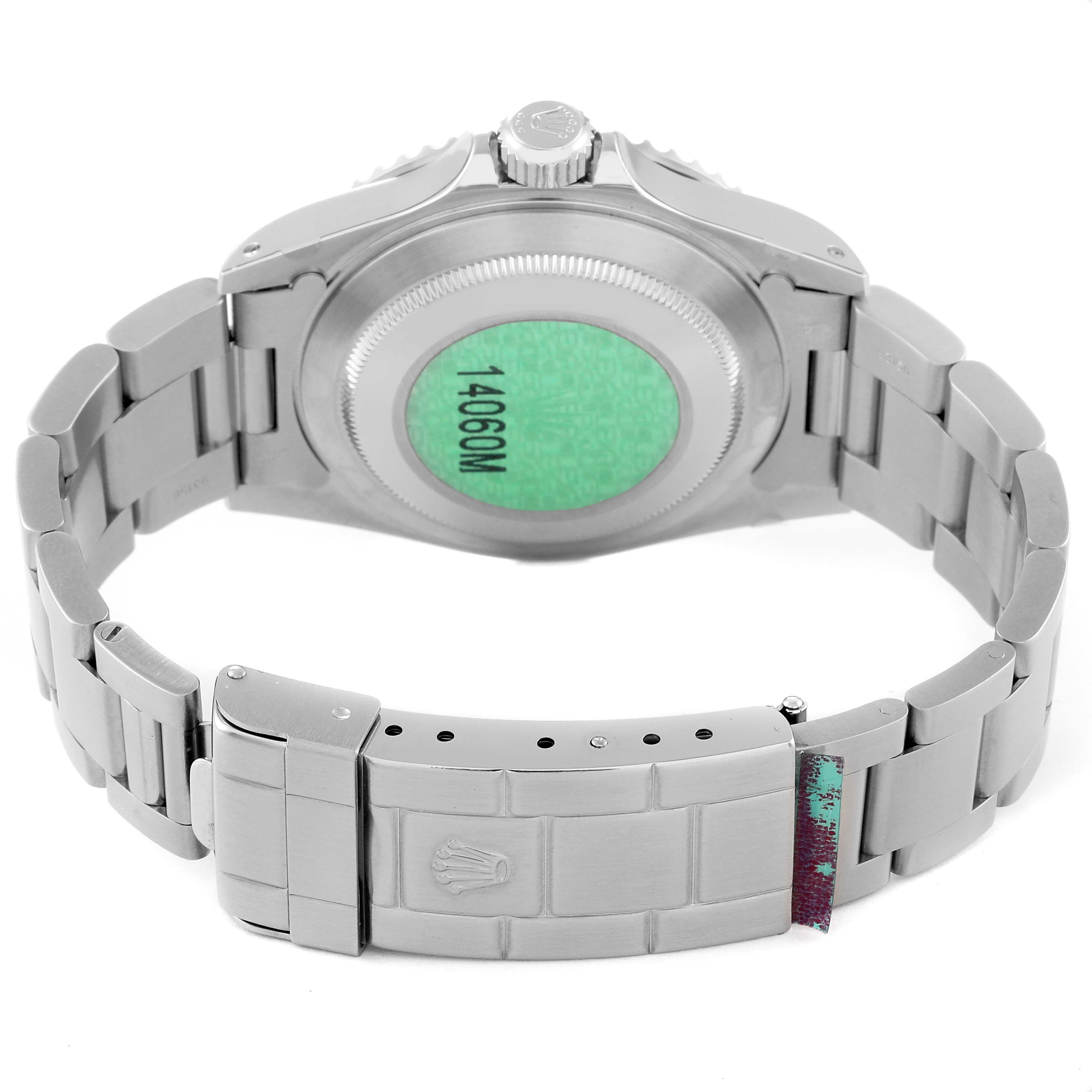 The image shows the back case and bracelet clasp of a Rolex Submariner 14060 Men
s Stainless Steel Black Dial 14060 Men
s Stainless Steel Black Dial watch, highlighting its crown and engraved details.