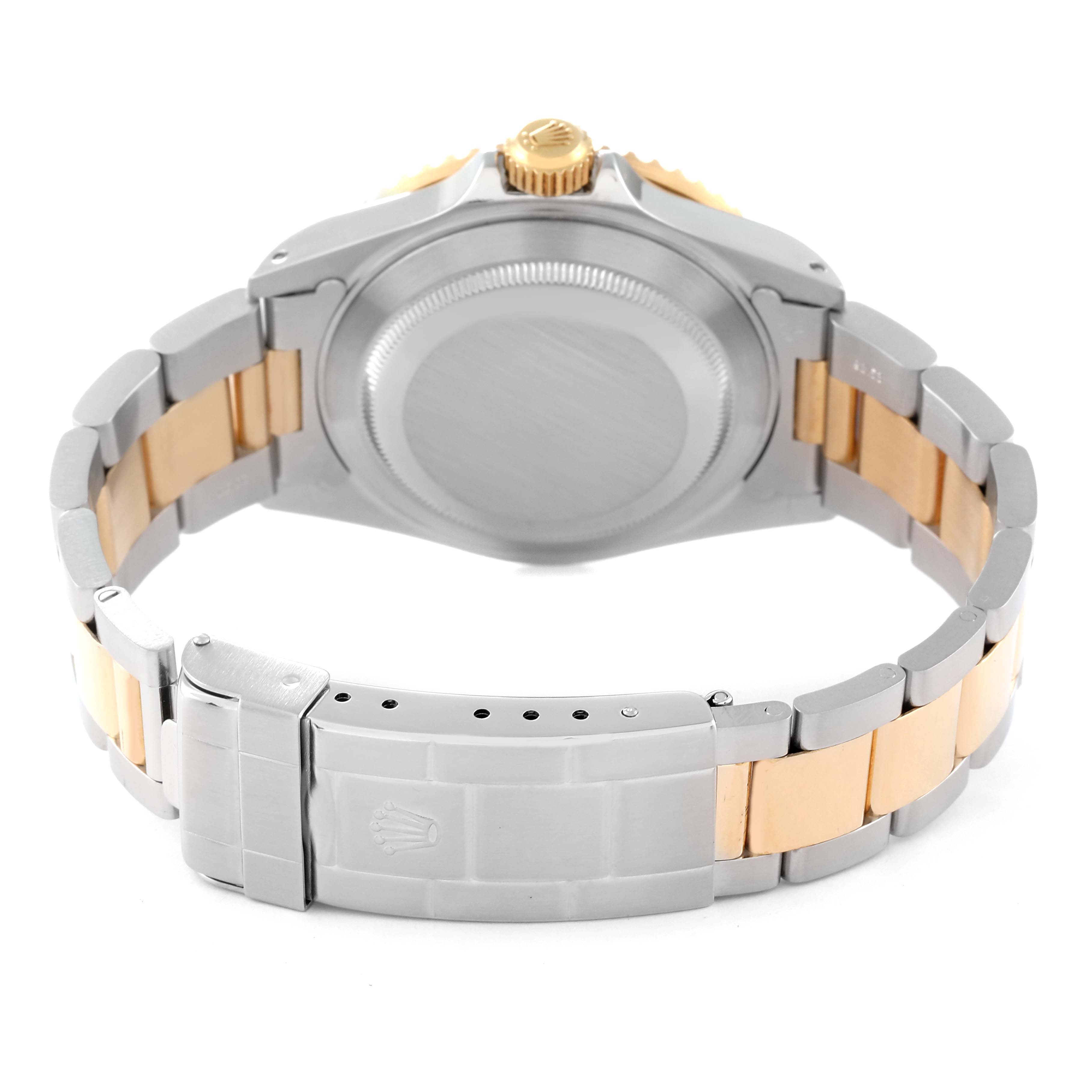 This is a rear view of the Rolex Submariner 16613 Men's Steel and Gold (two tone) Black Dial 16613 Men's Steel and Gold (two tone) Black Dial, showing its case back, crown, and bi-metal bracelet with clasp.