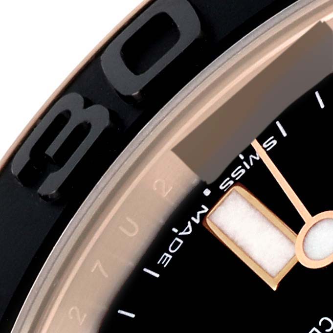 Close-up of a Rolex Yacht-Master 268655 Men's Rose Gold Black Dial 268655 Men's Rose Gold Black Dial showing part of the bezel, dial, and markers at an angle.