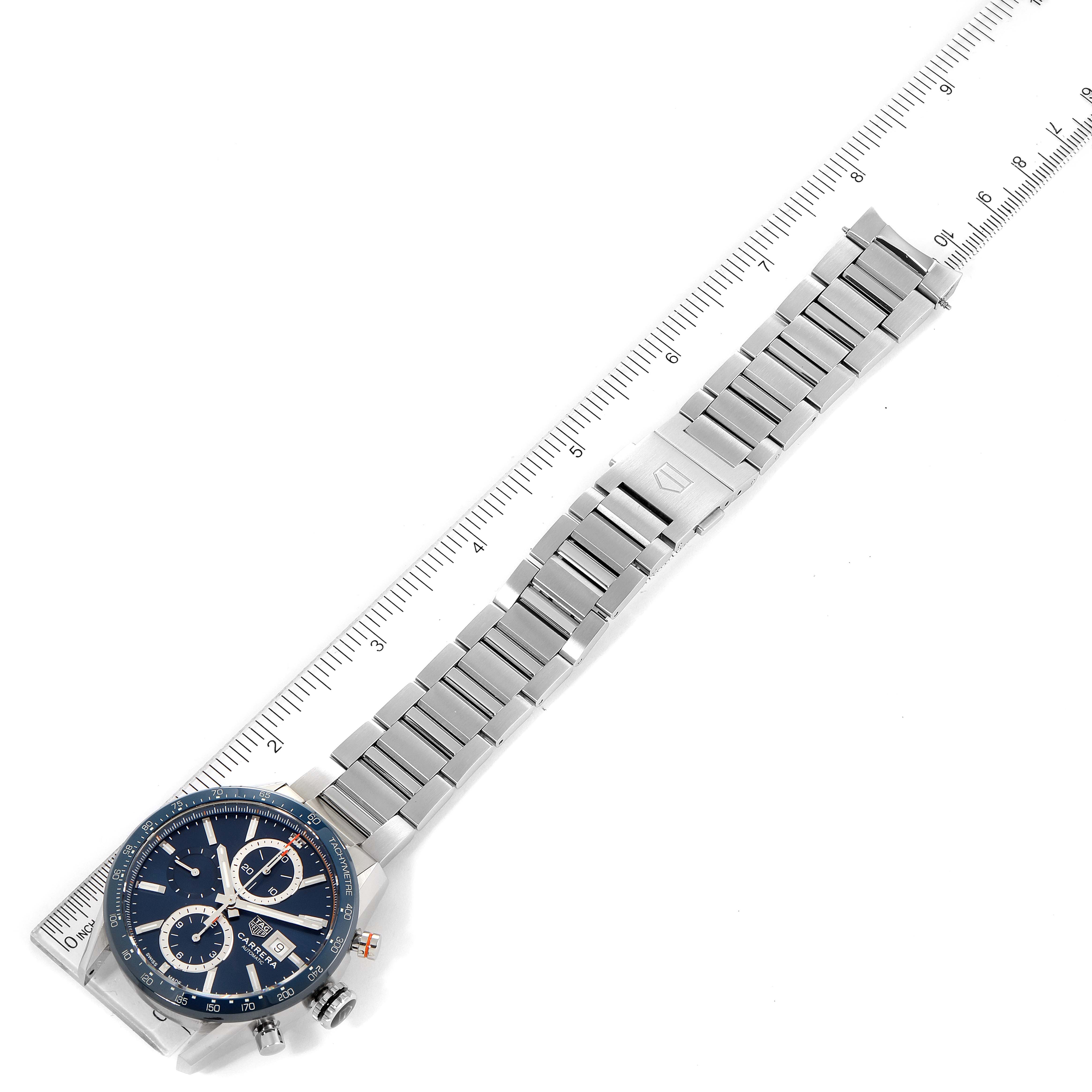 The image shows the face and stainless steel bracelet of a Tag Heuer Carrera CBM2112.BA0651 Men's Stainless Steel Blue Dial CBM2112.BA0651 Men's Stainless Steel Blue Dial watch at a slight angled side view, with a ruler for measurement.