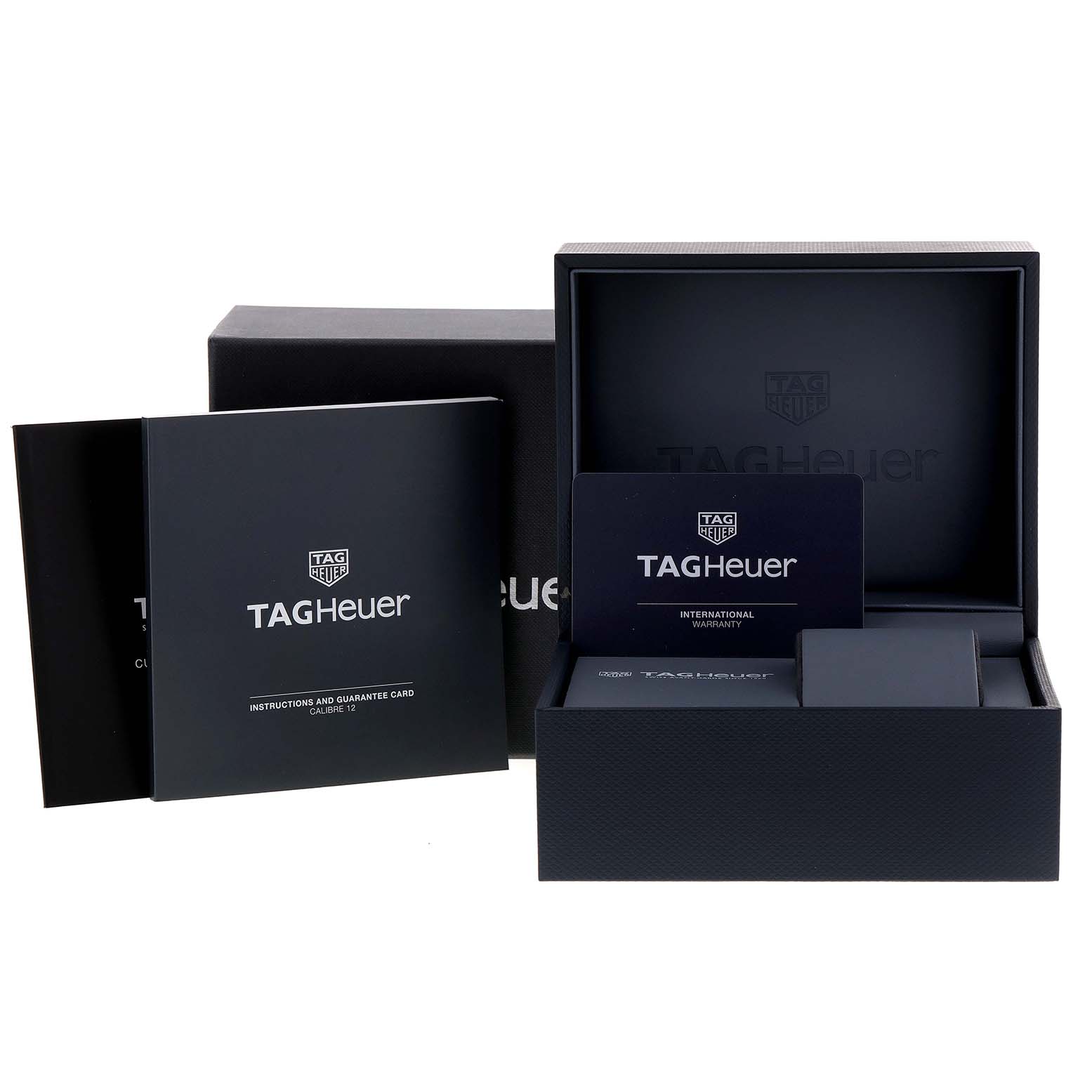 The image shows the packaging, user manual, and warranty card for the Tag Heuer Monaco model watch.