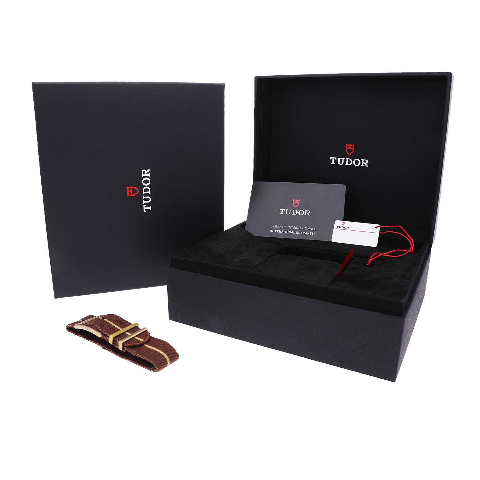 The image shows the Tudor Heritage Black Bay M79012M-0001 Men's Bronze Brown Dial's box, warranty card, tag, and an additional strap.