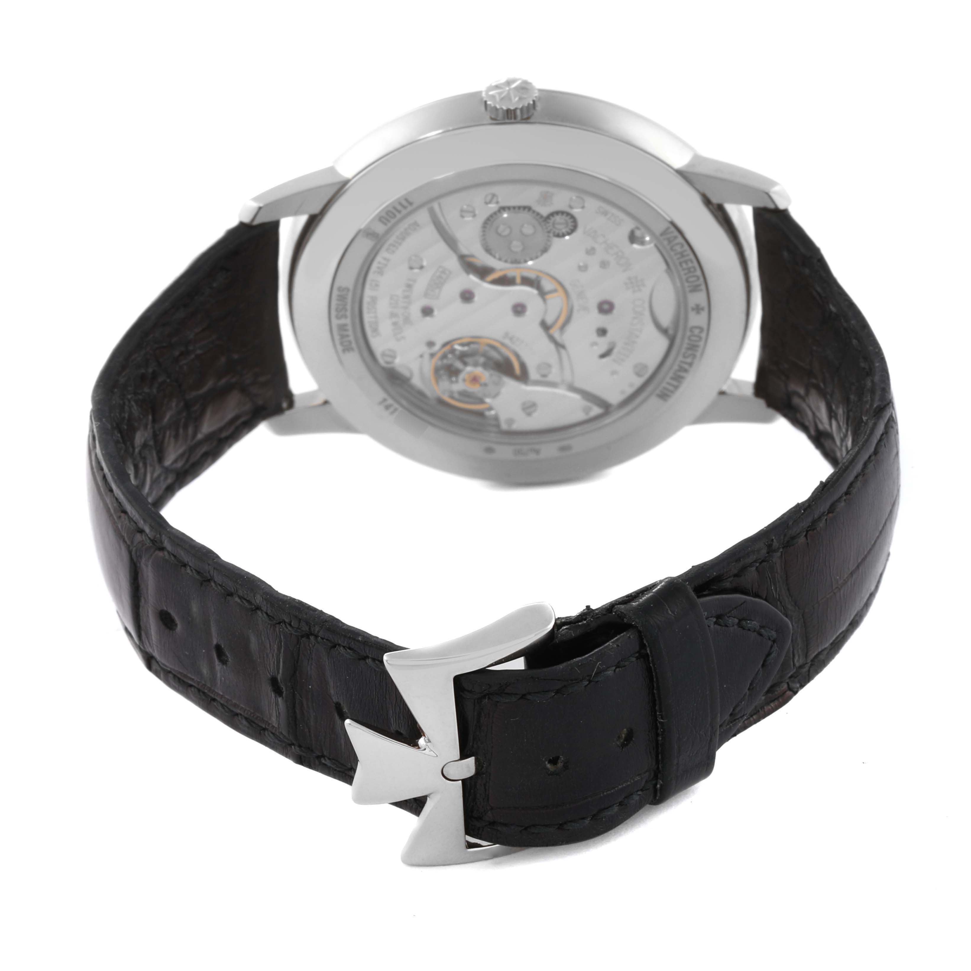 The image shows the back view of the Vacheron Constantin Patrimony 1110U/000G-B086 Men's White Gold Silver Dial 1110U/000G-B086 Men's White Gold Silver Dial watch, highlighting its movement and black leather strap with a distinctive buckle.