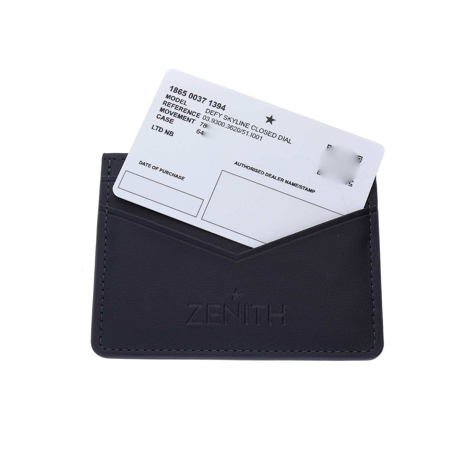 The image shows a Zenith-branded cardholder with a warranty card for the Defy model inserted.