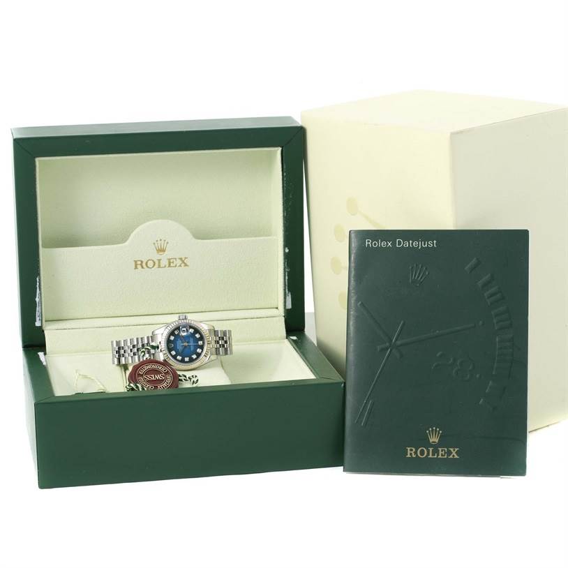 The image shows a Rolex 179174 Women's Stainless Steel Blue Dial 179174 Women's Stainless Steel Blue Dial Datejust Steel White Gold Vignette Diamond Dial Watch 179174 in a green box, with a booklet beside it.