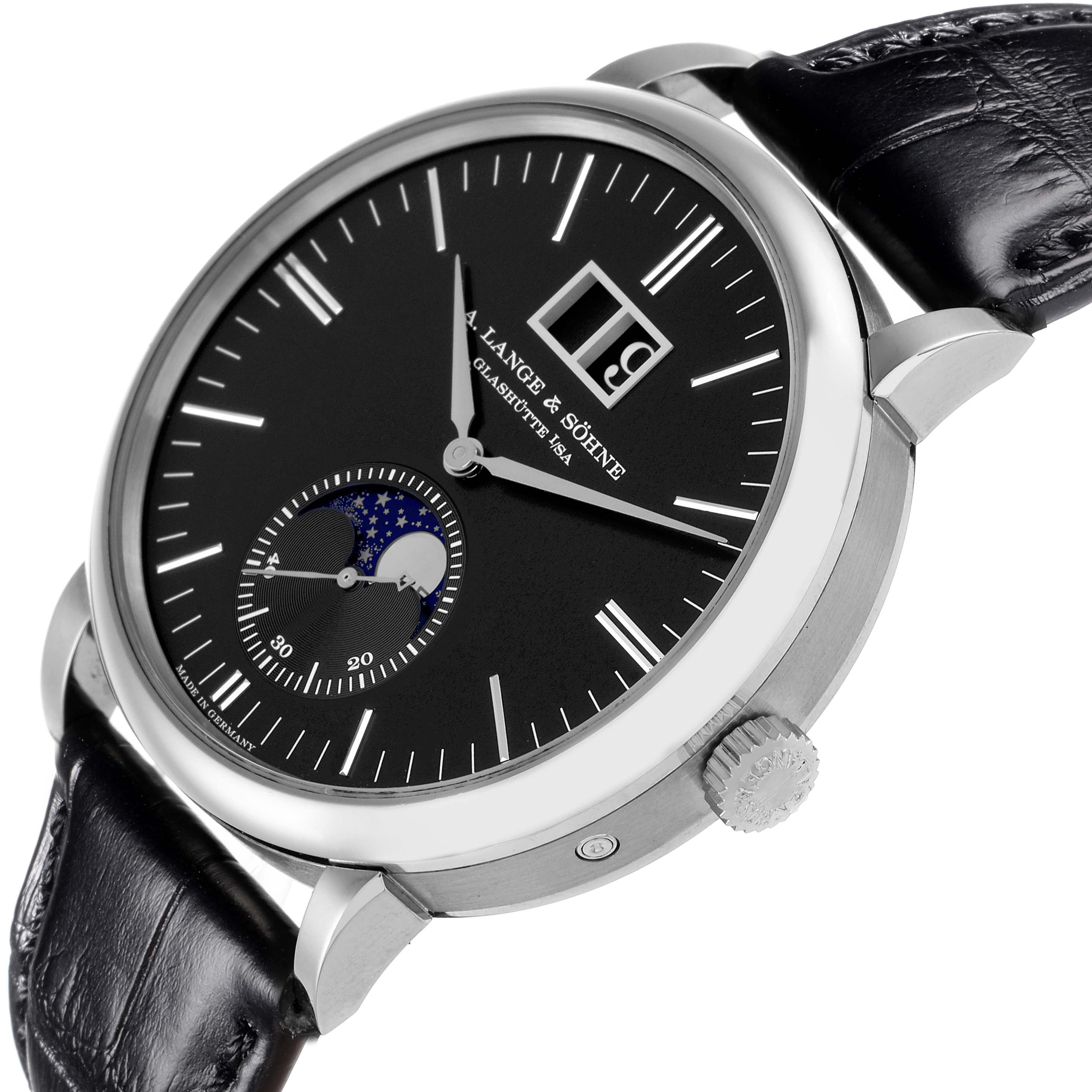 The image shows an angled view of the A. Lange 
Sohne Saxonia 384.029 Men
s White Gold Black Dial watch, highlighting the dial, crown, and leather strap.