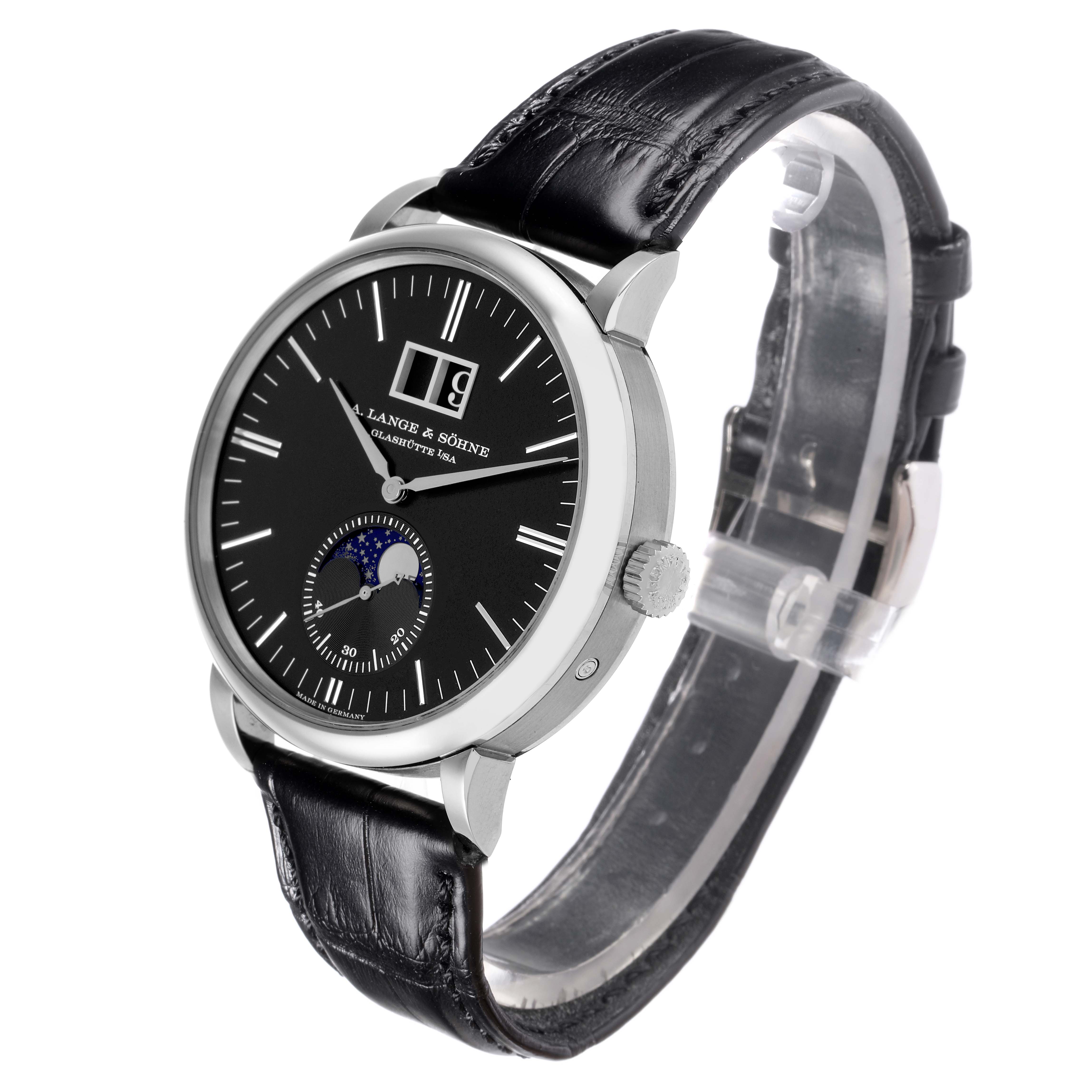 The A. Lange 
Sohne Saxonia 384.029 Men
s White Gold Black Dial watch is shown at a three-quarter angle, highlighting the dial, strap, crown, and lugs.