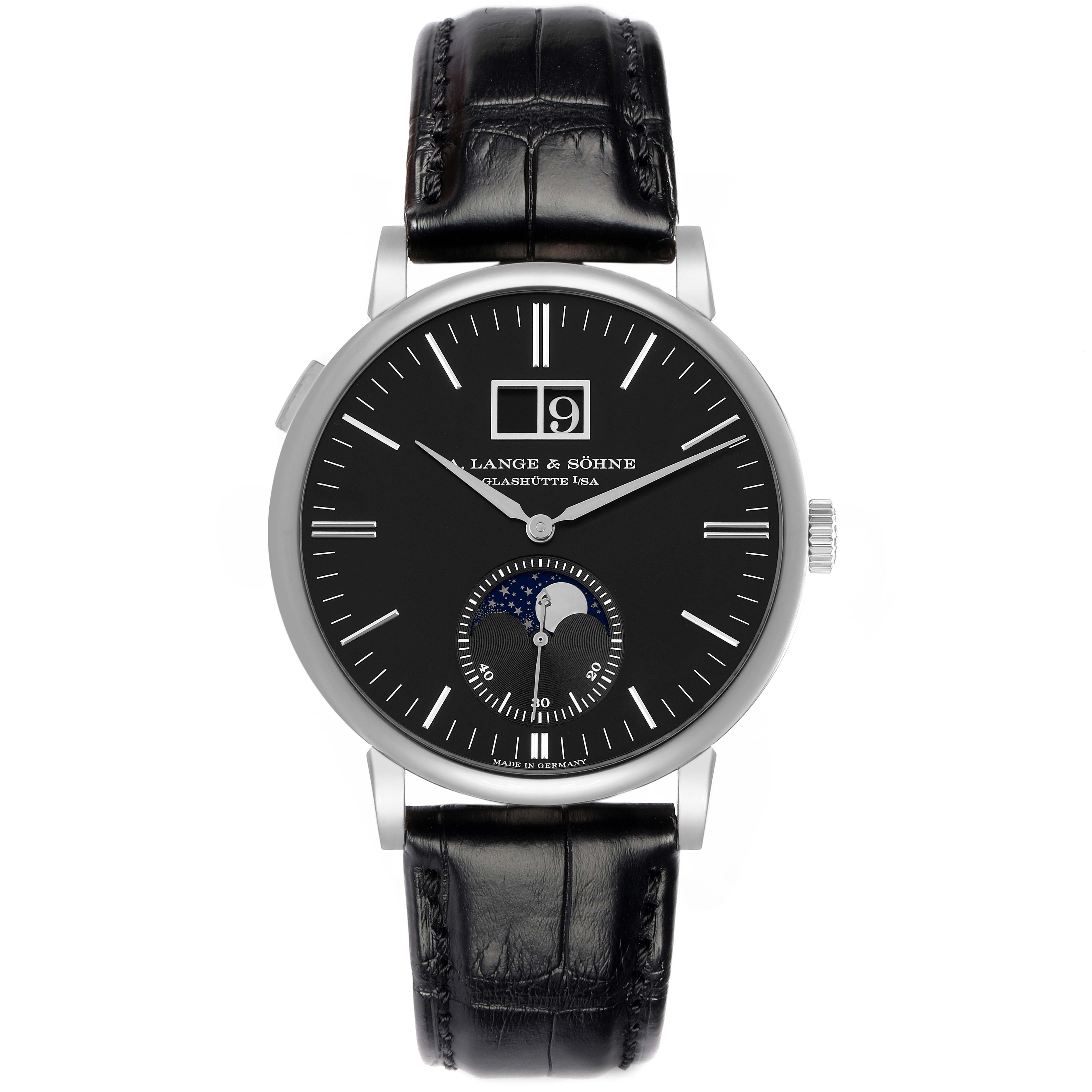 The A. Lange 
Sohne Saxonia 384.029 Men
s White Gold Black Dial watch is shown from the front, displaying its dial, leather strap, and crown.